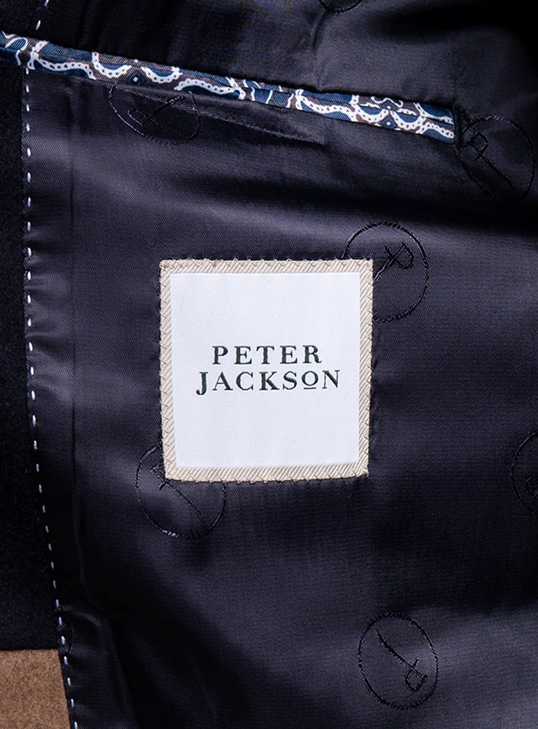 The Peter Jackson logo on the Signature Wool Pile Navy Blue Coat