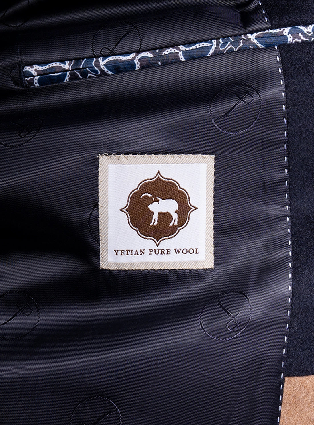 A label that says "Yetian Pure Wool" on the Signature Wool Pile Navy Blue Coat
