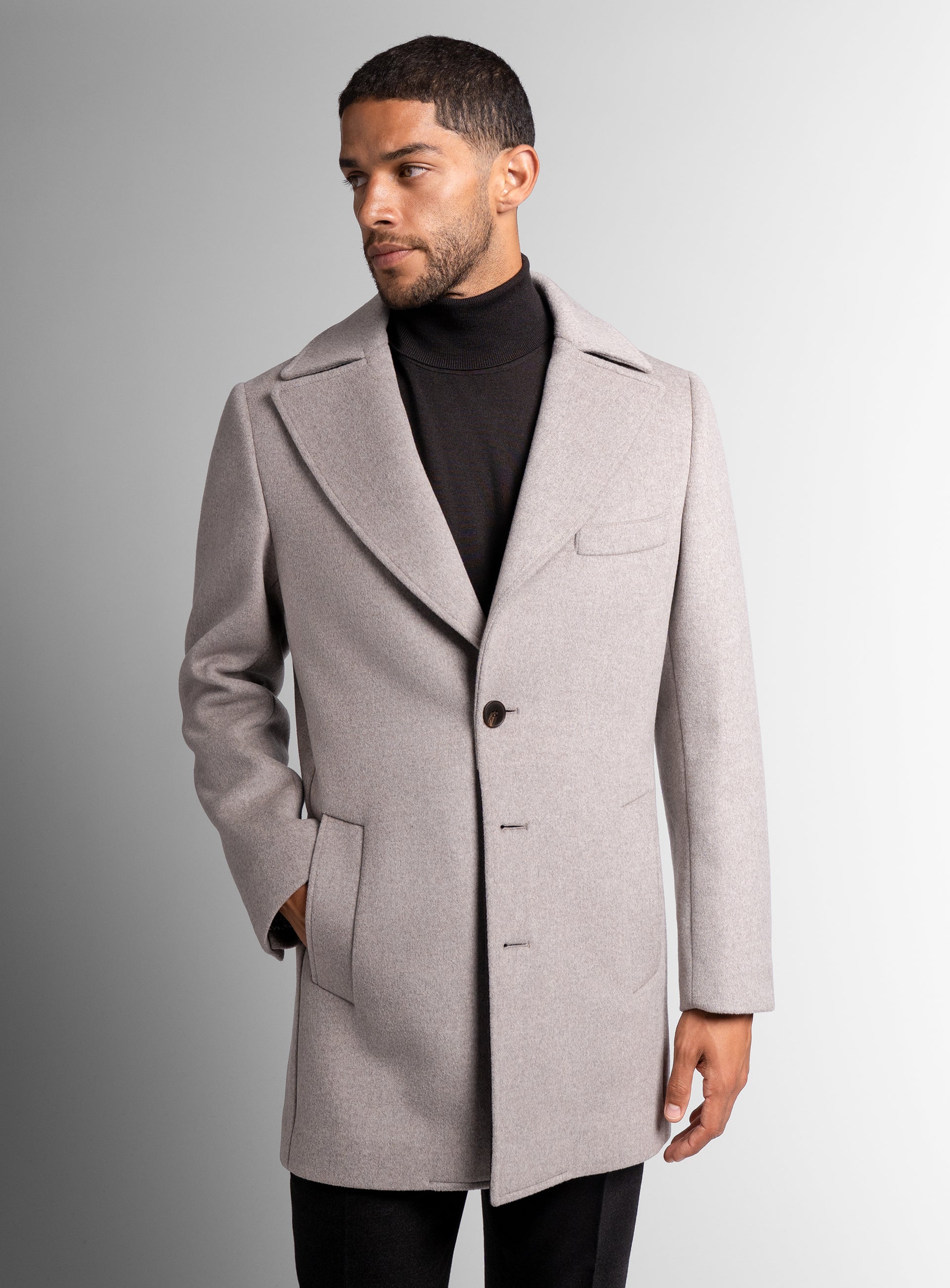 A man looking to his side wearing the Gallio Wool Pile Oat Beige Coat