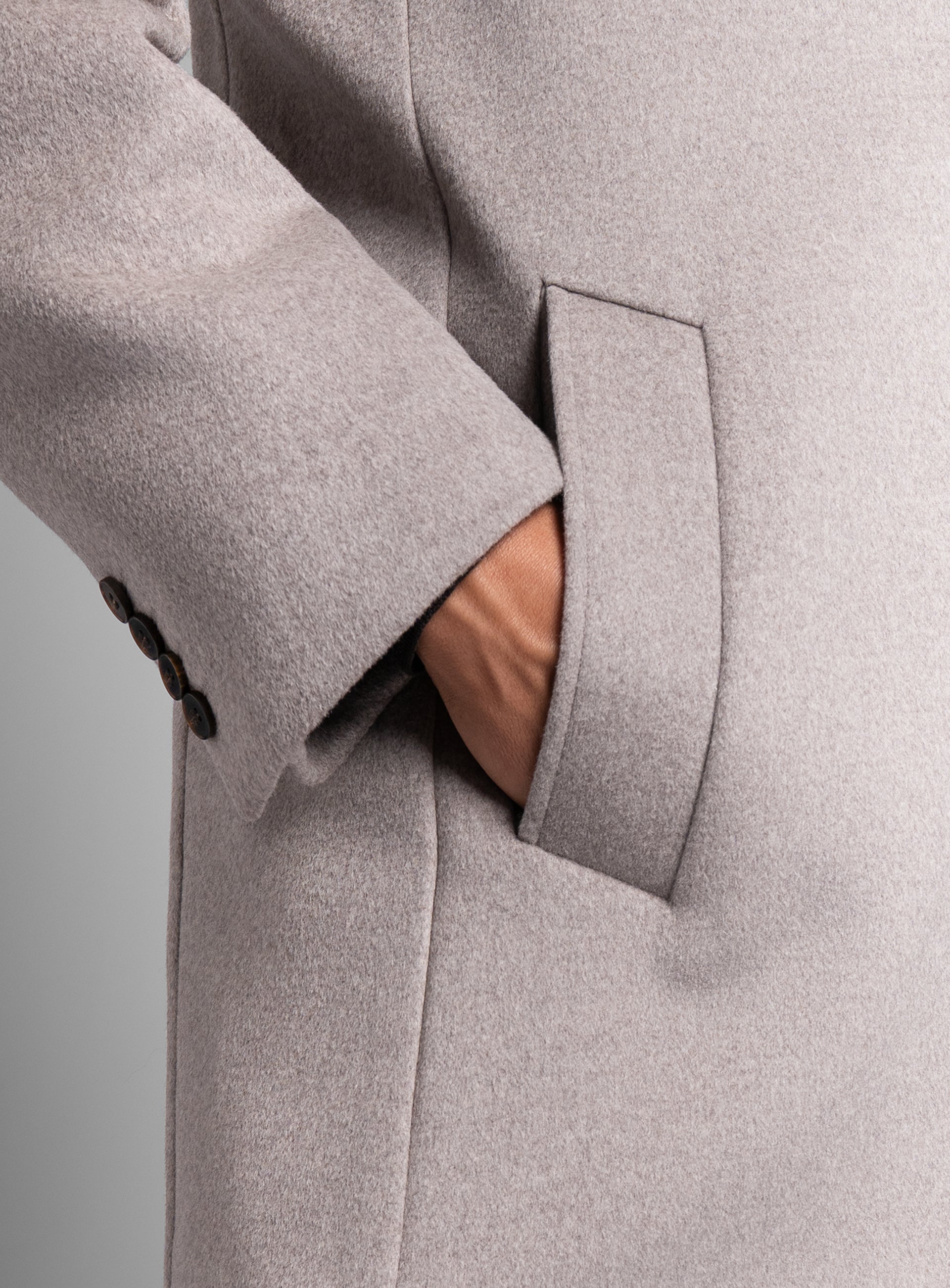 A man wearing the Gallio Wool Pile Oat Beige Coat with his hand in his pocket