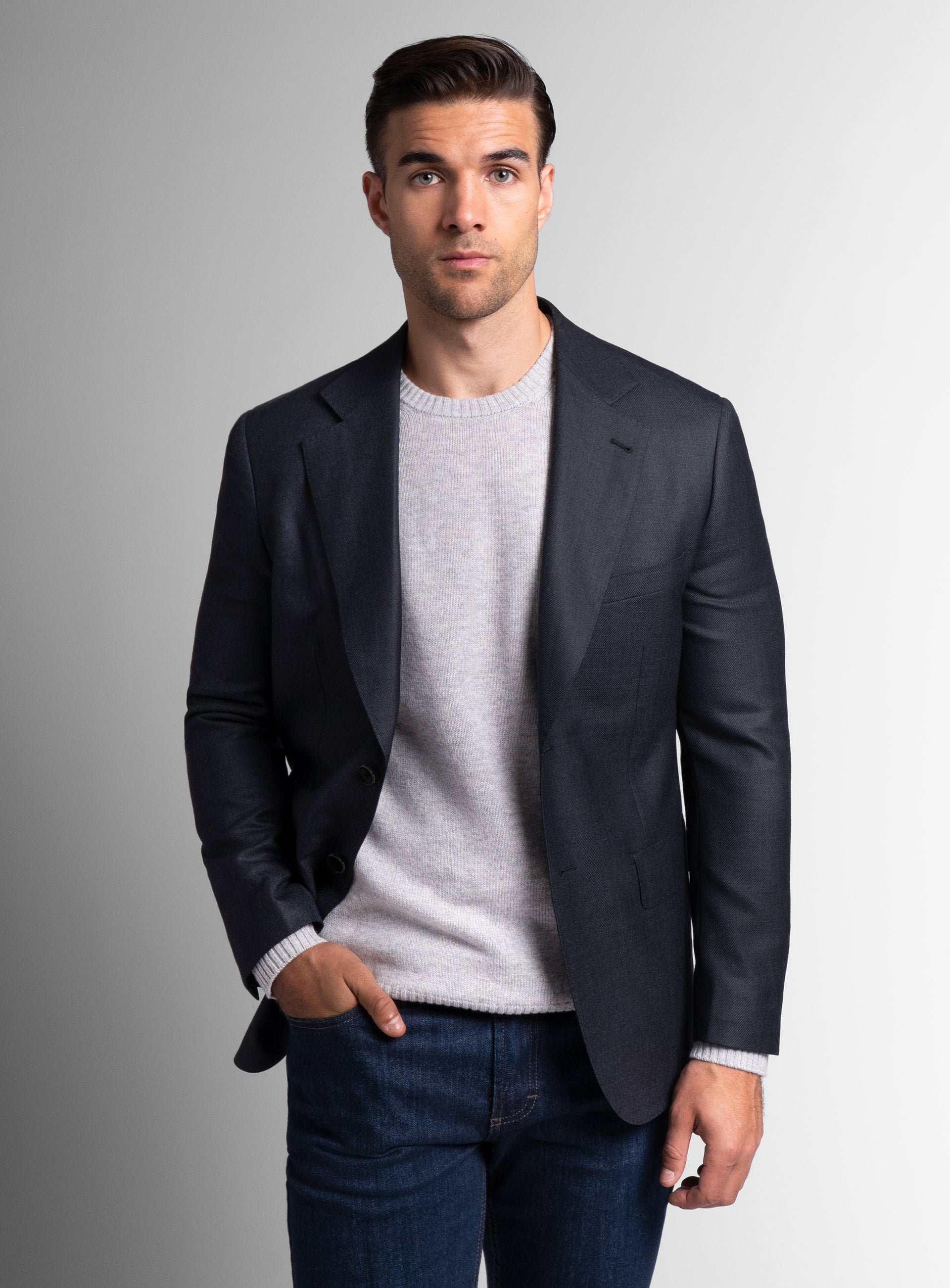 A man wearing the Vito Twill Black Jacket with his hand in his pocket