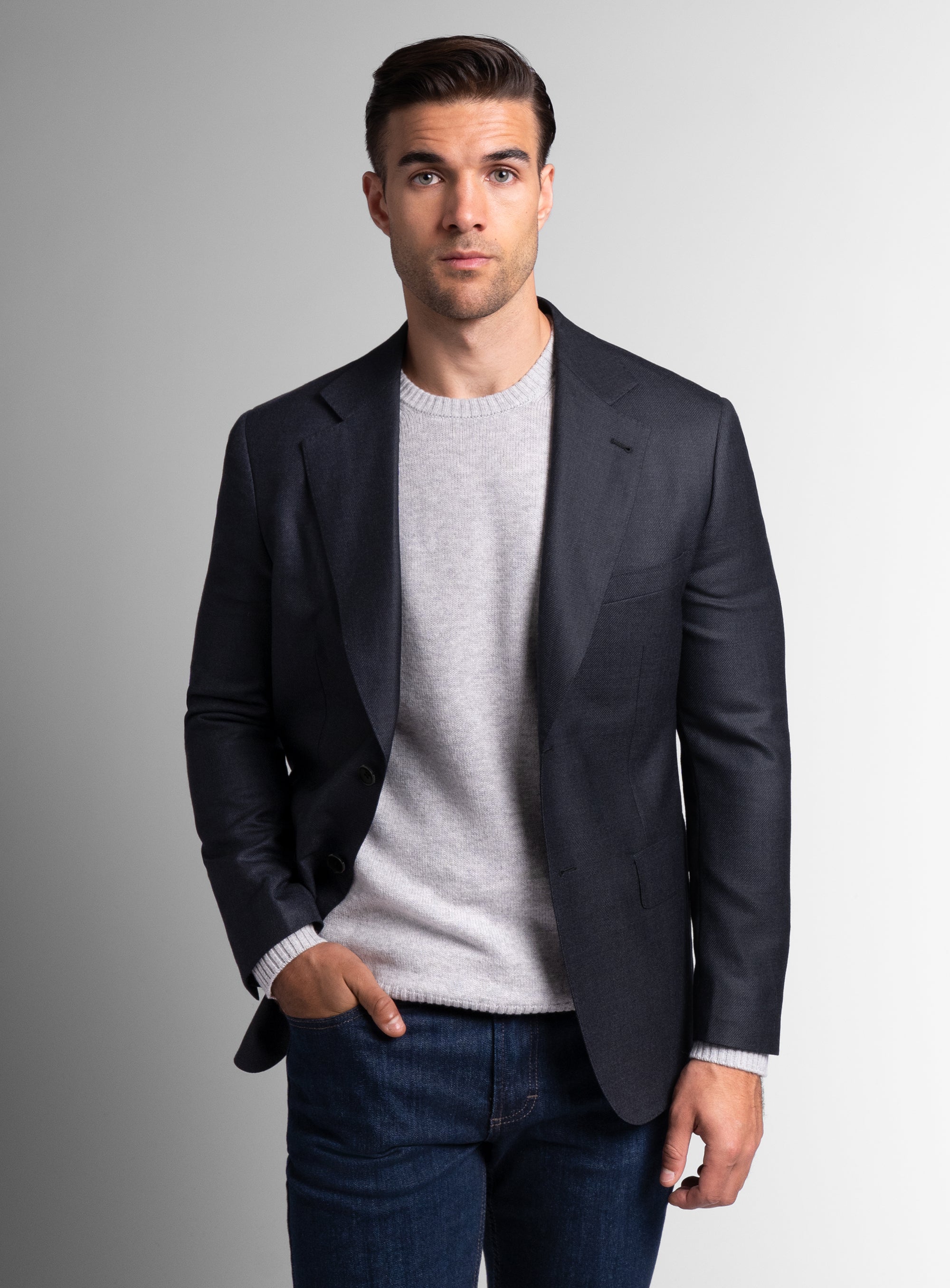 A man wearing the Vito Twill Black Jacket with his hand in his pocket