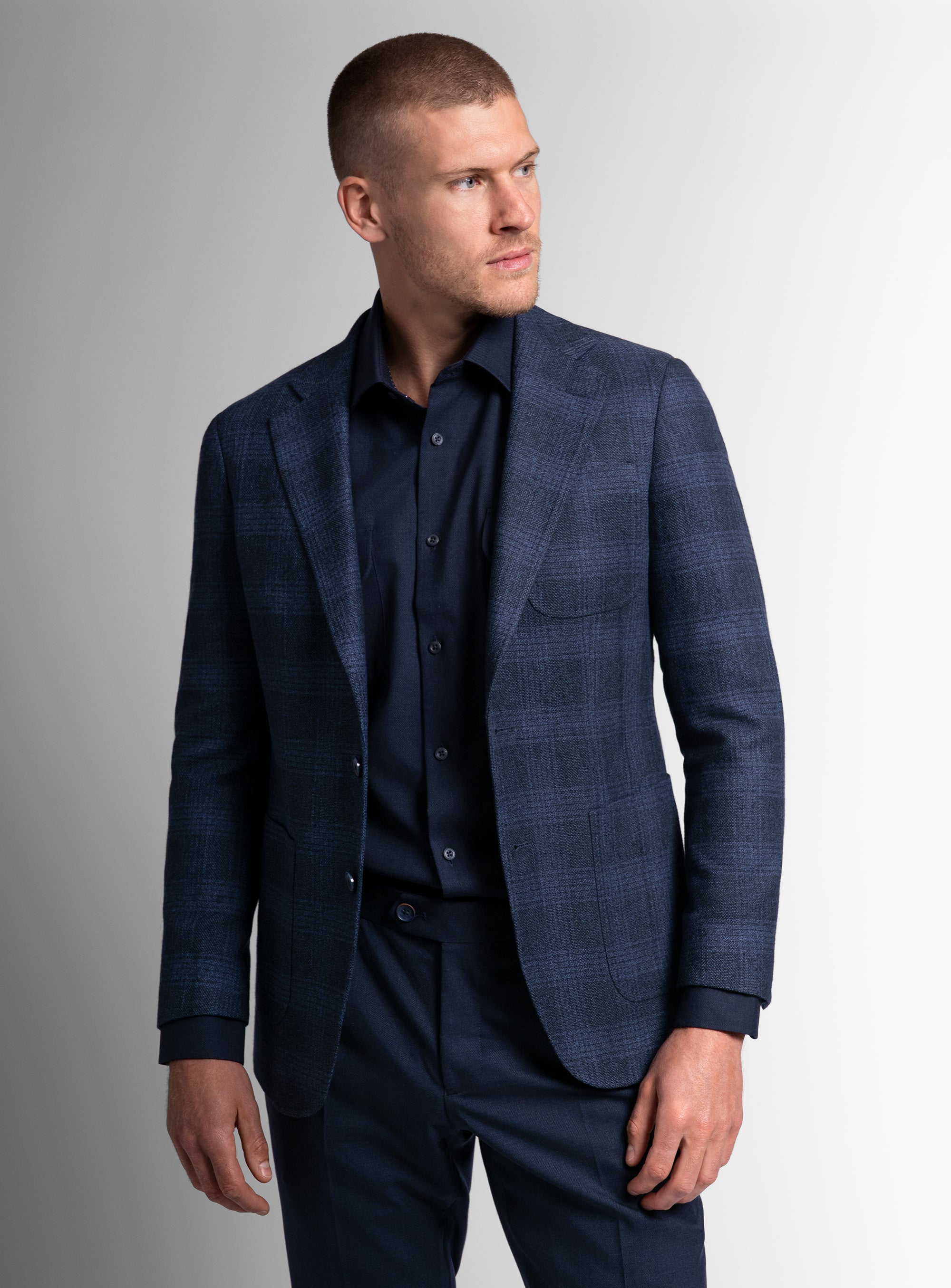 Man wearing the Luzio Milled Plaid Navy Jacket