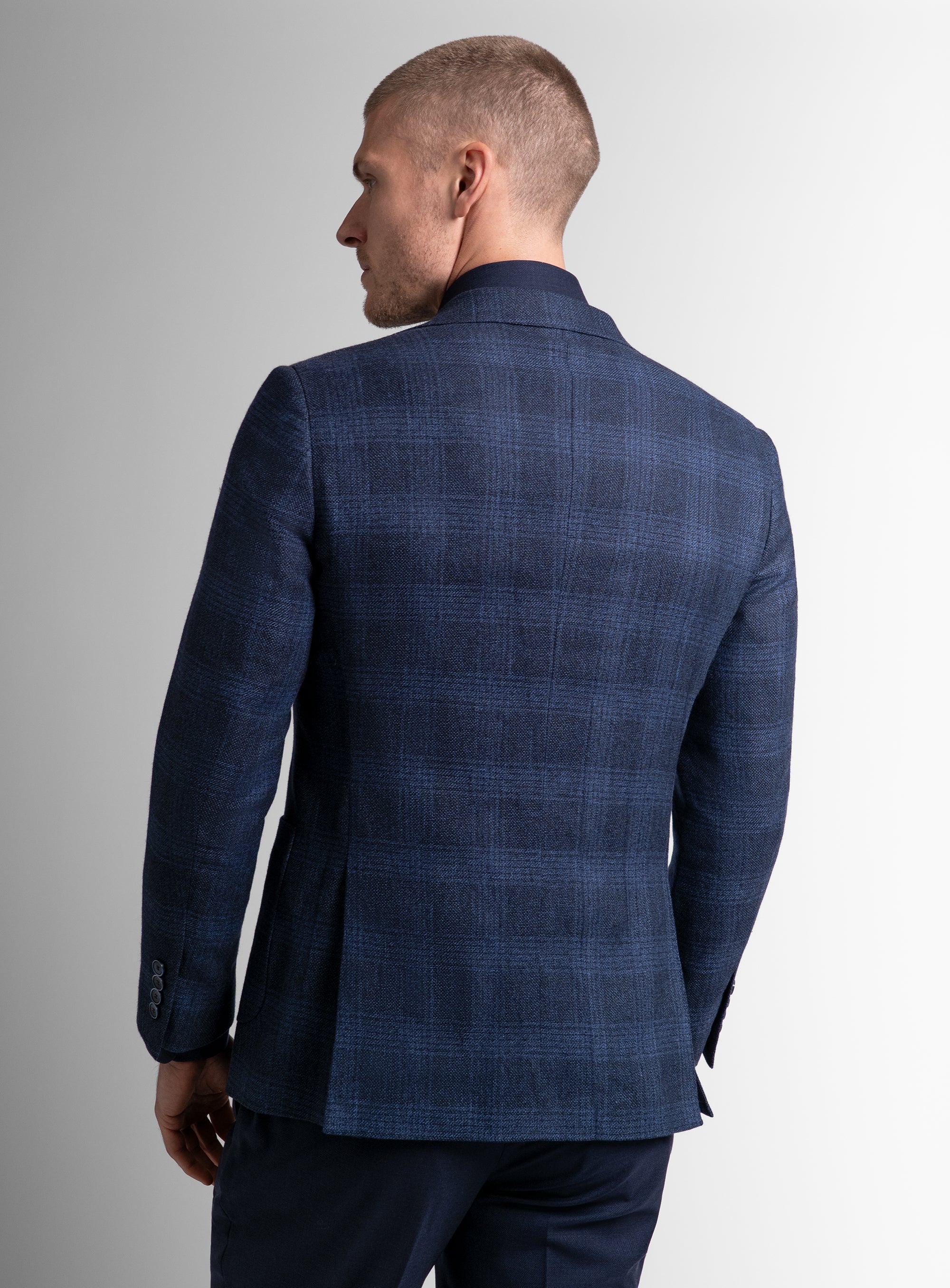 The back of the Luzio Milled Plaid Navy Jacket