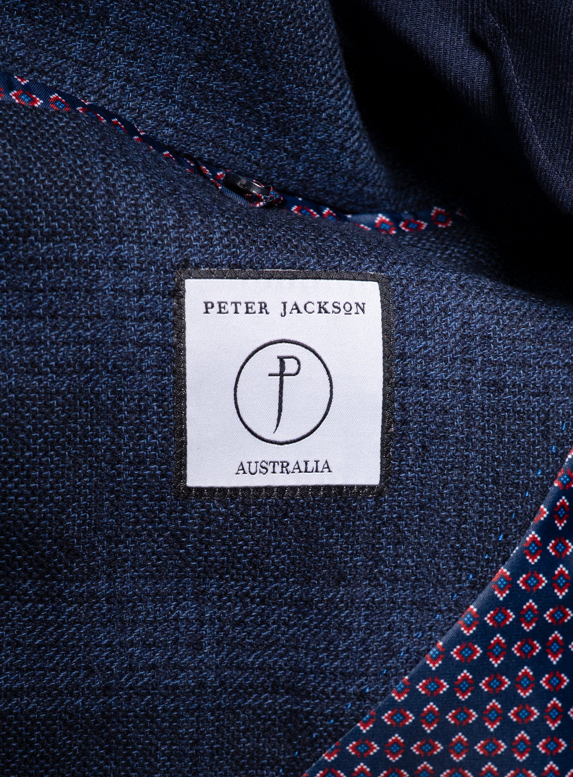 Label that says "Peter Jackson Australia" on the Luzio Milled Plaid Navy Jacket