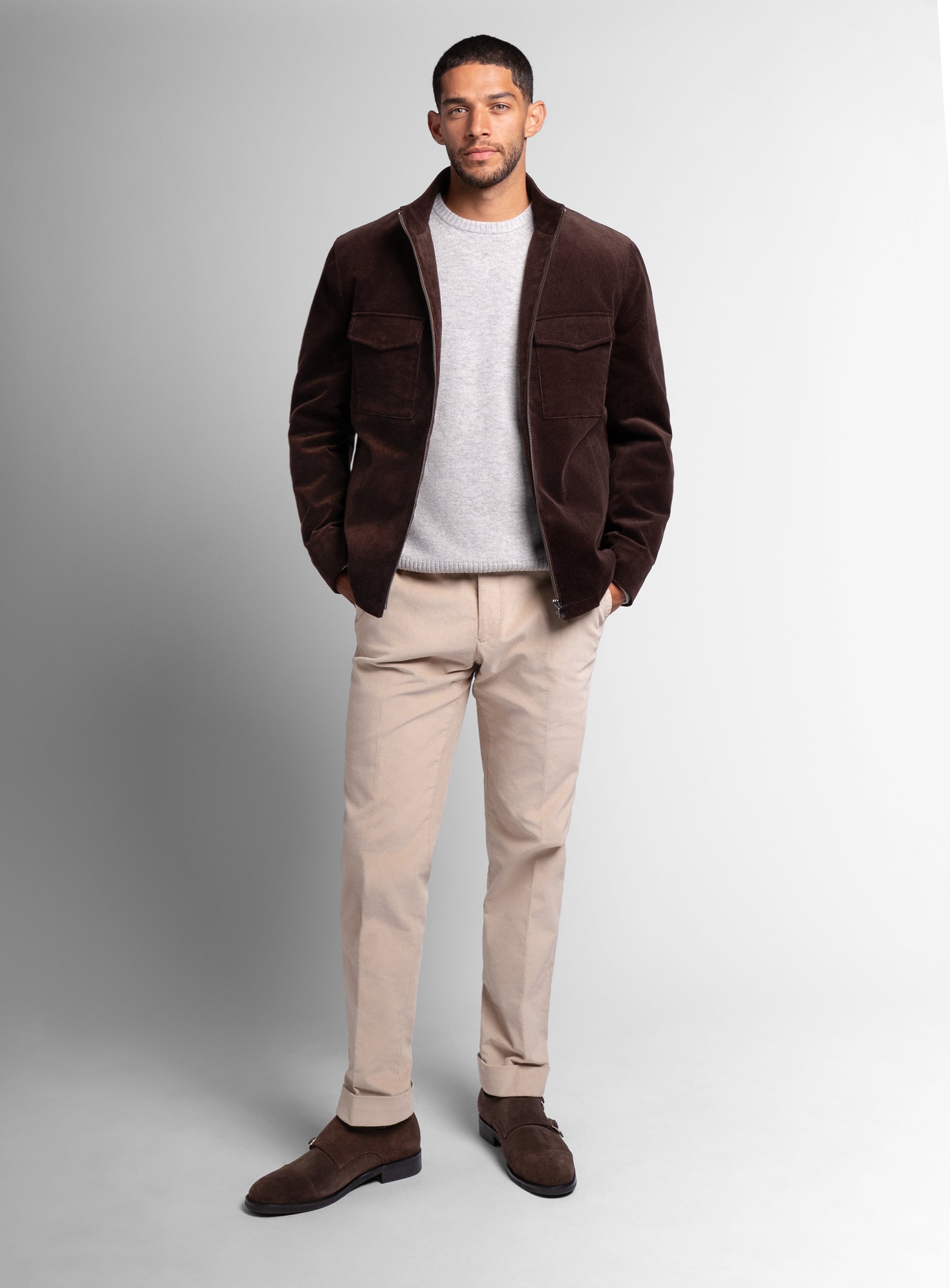 A man wearing the Aldor Corduroy Chocolate Brown Jacket