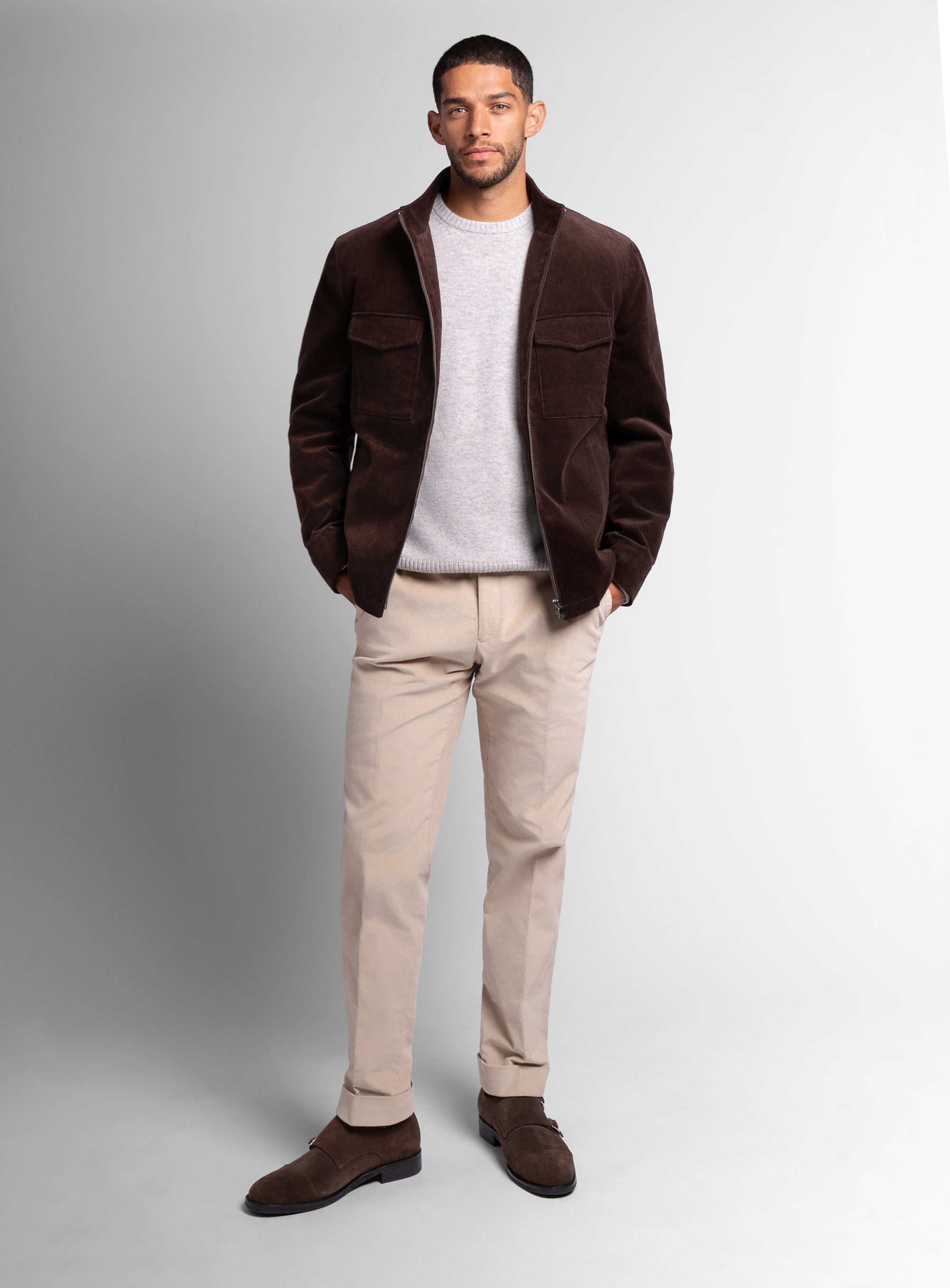 A man wearing the Aldor Corduroy Chocolate Brown Jacket