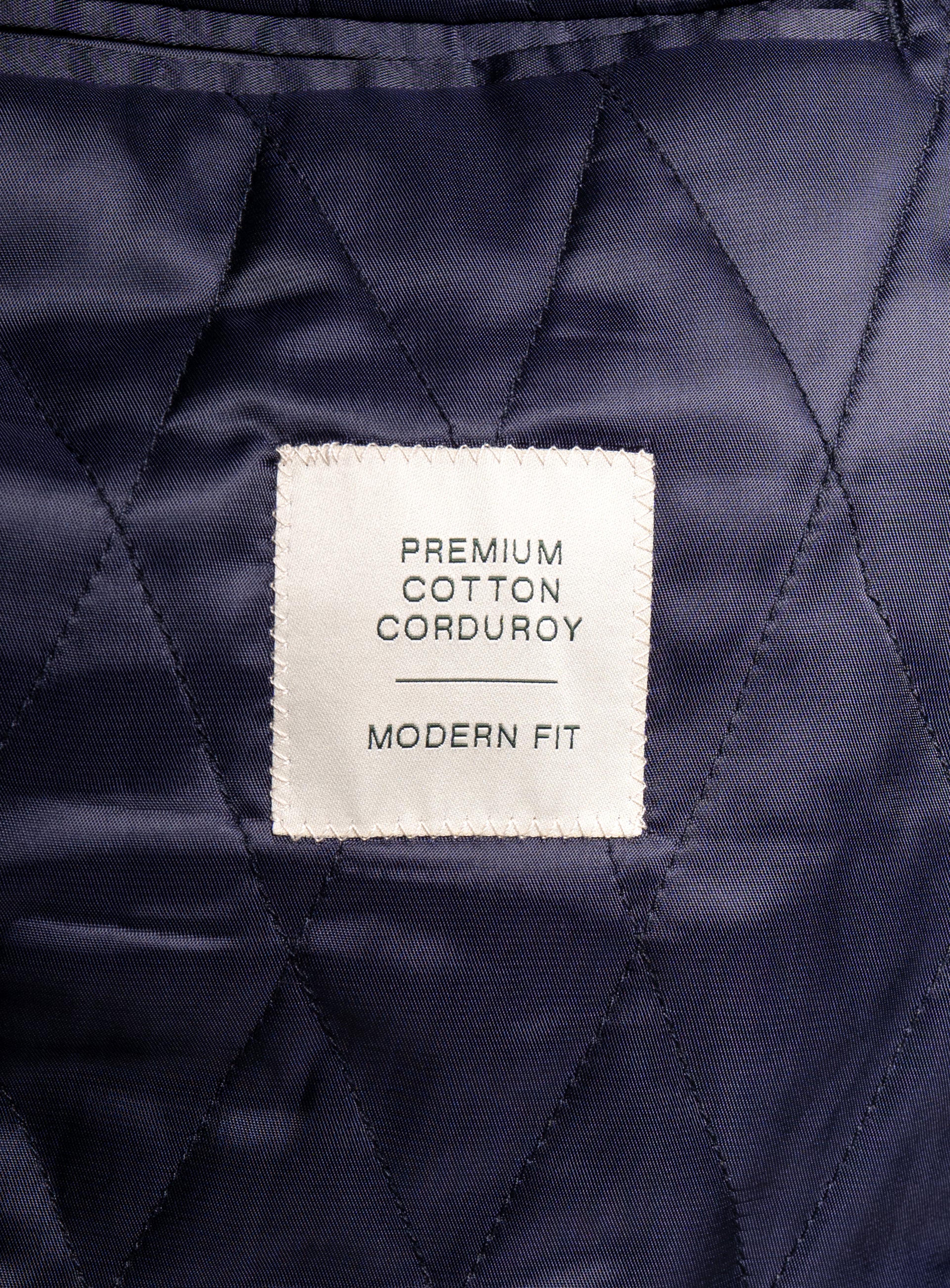 A label that says "Premium Cotton Corduroy - Modern Fit" on the Aldor Corduroy Chocolate Brown Jacket