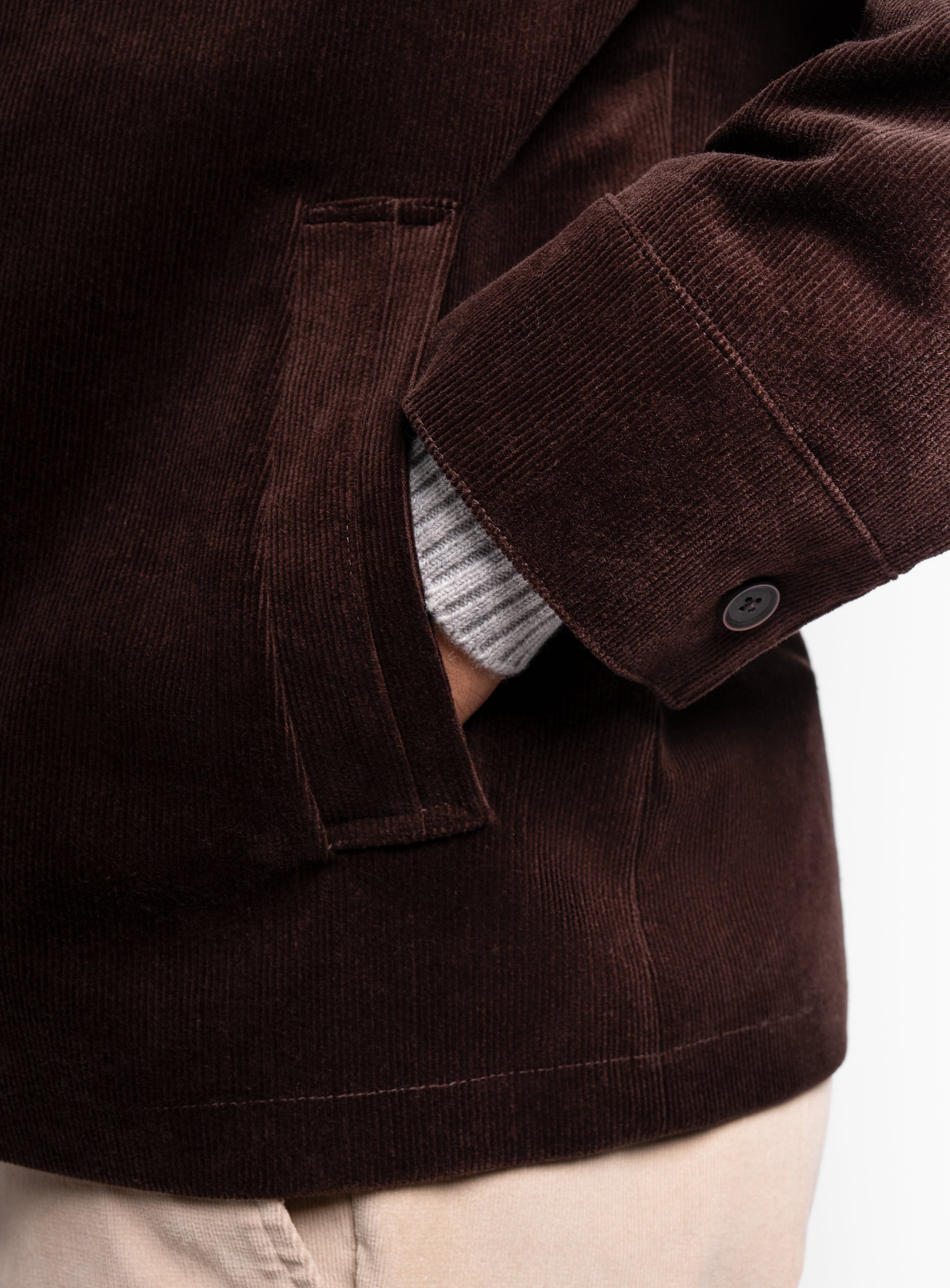 A man with his hand in his pocket wearing the Aldor Corduroy Chocolate Brown Jacket