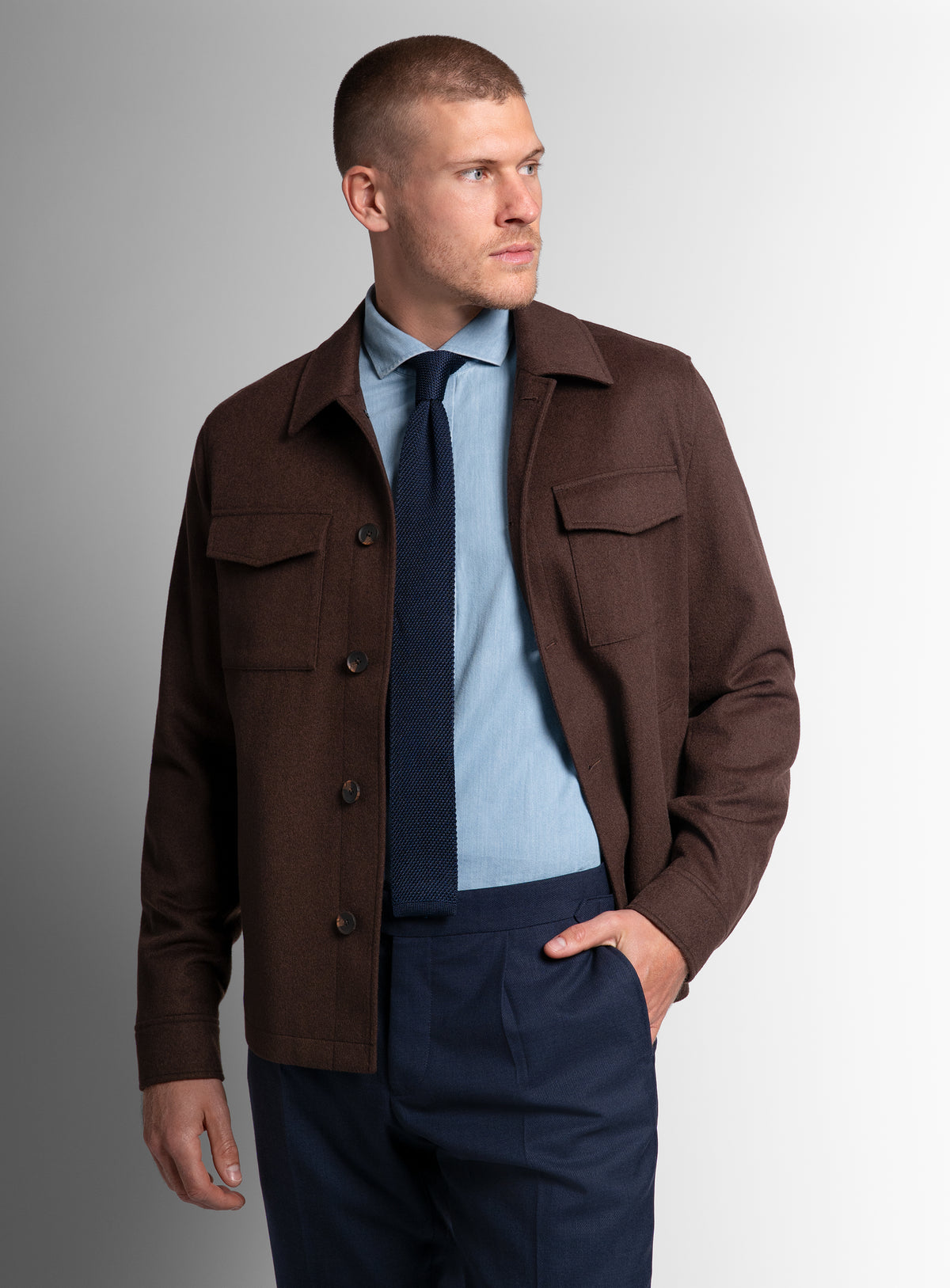 A man wearing the Orlando Chocolate Brown Jacket with his hand in his pocket