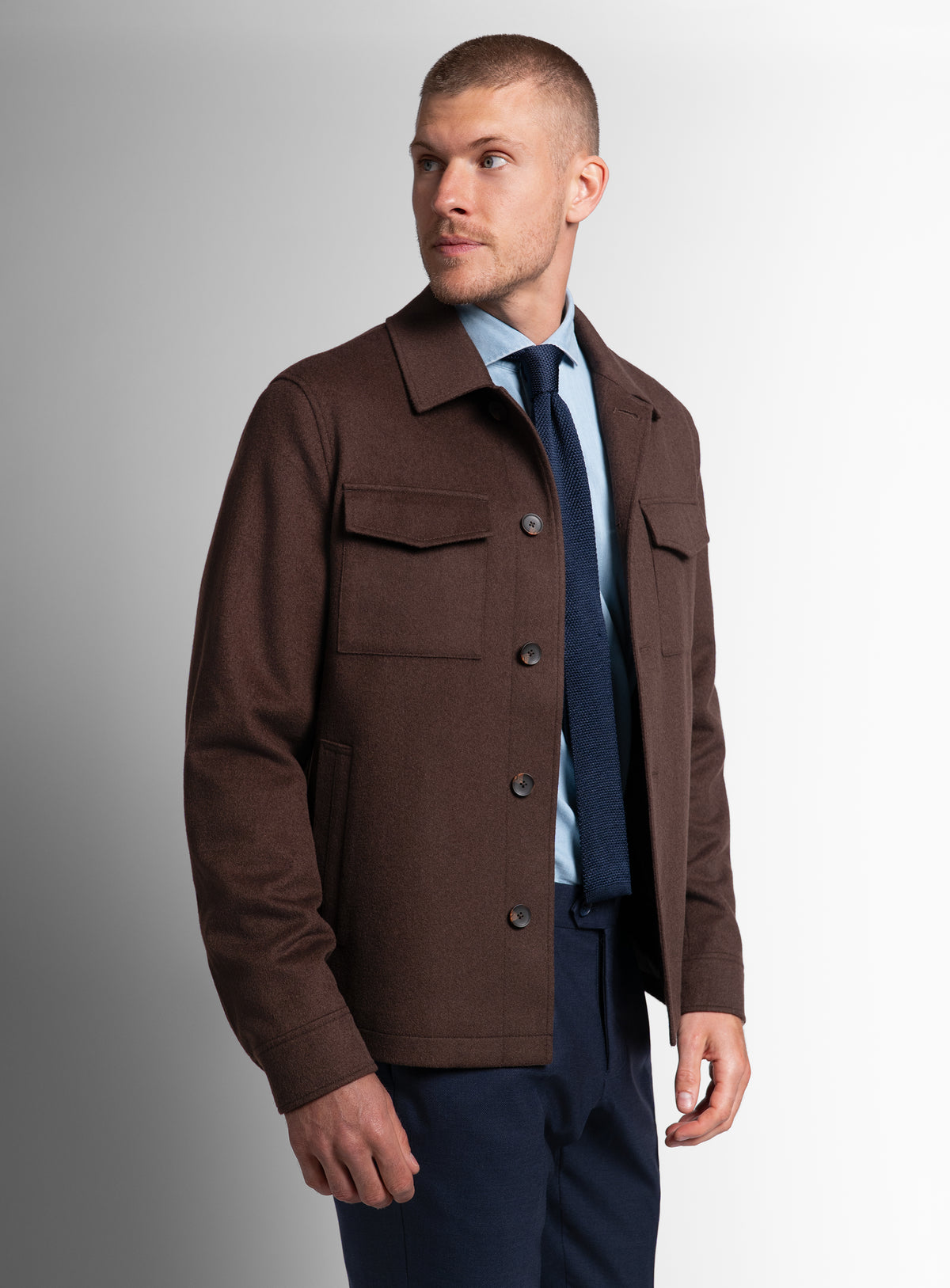 A man looking to his side while wearing the Orlando Chocolate Brown Jacket