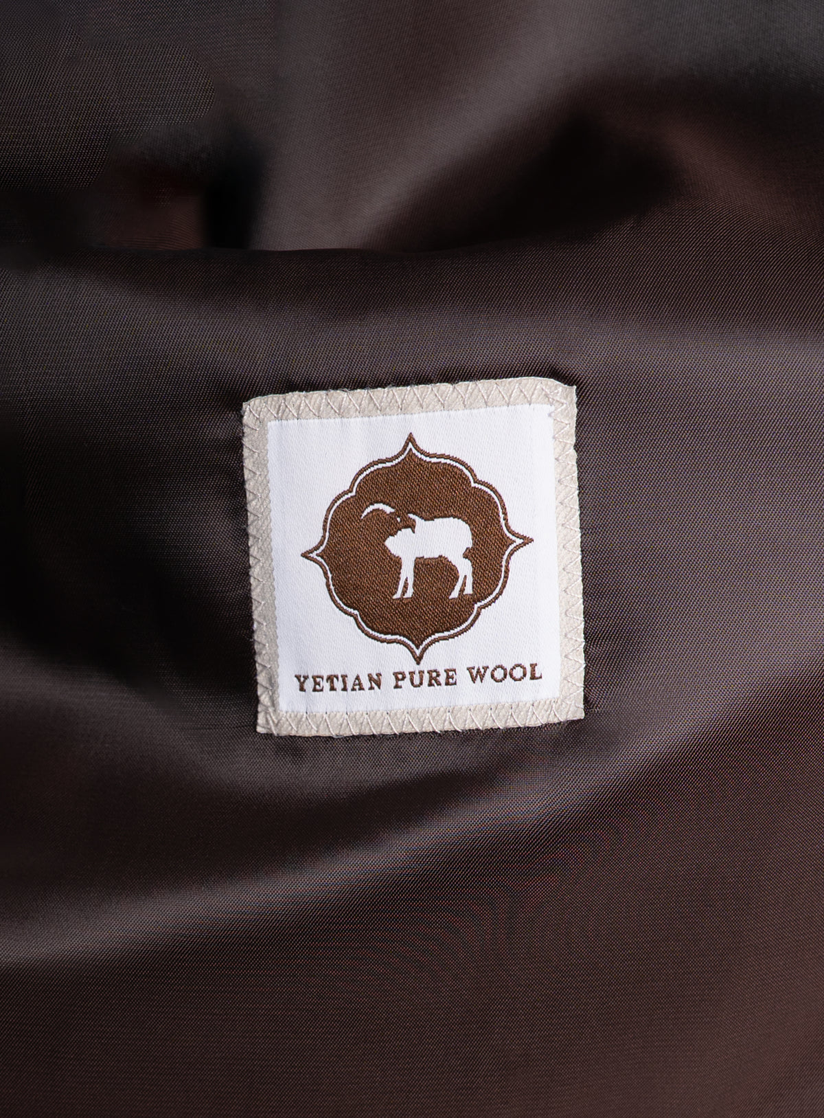 A label that says "Yetian Pure Wool" on the Orlando Chocolate Brown Jacket