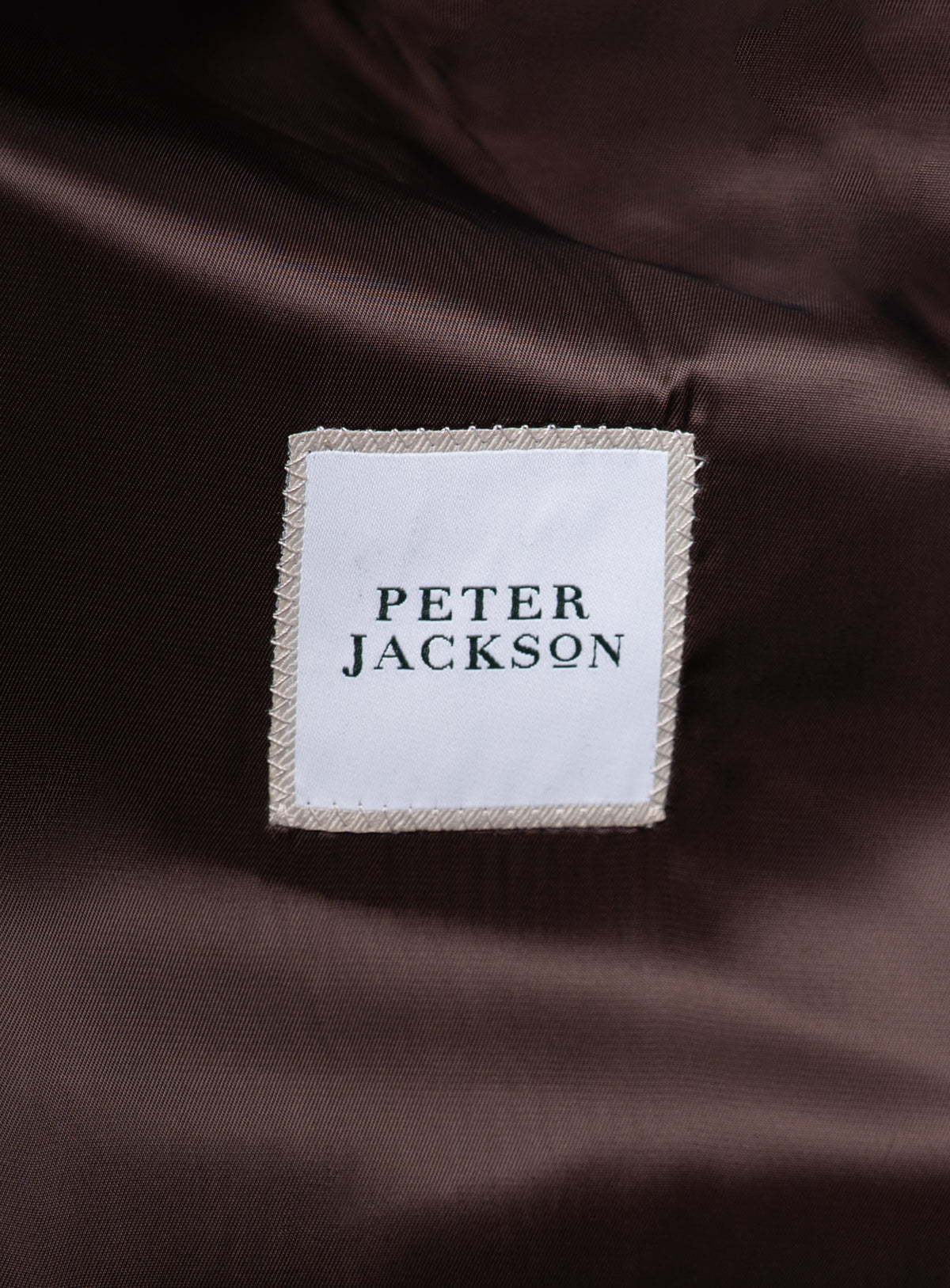 Close-up of the "Peter Jackson" logo on the Orlando Chocolate Brown Jacket