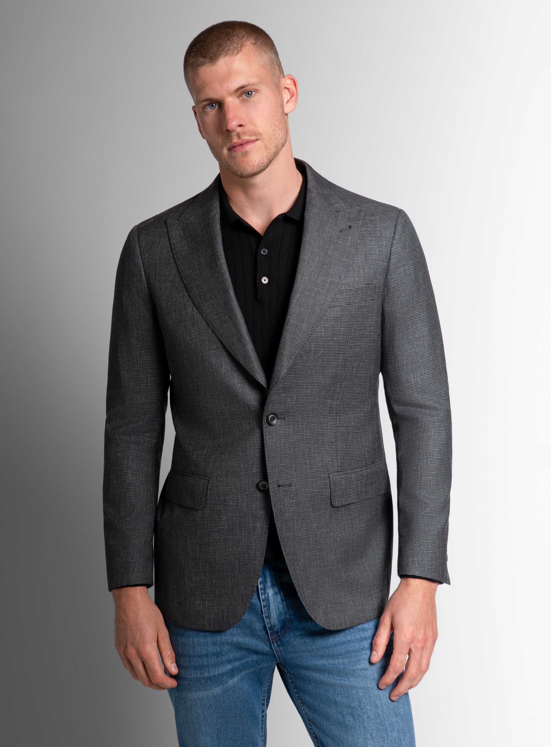 A man wearing the Portici Puppytooth Green Jacket