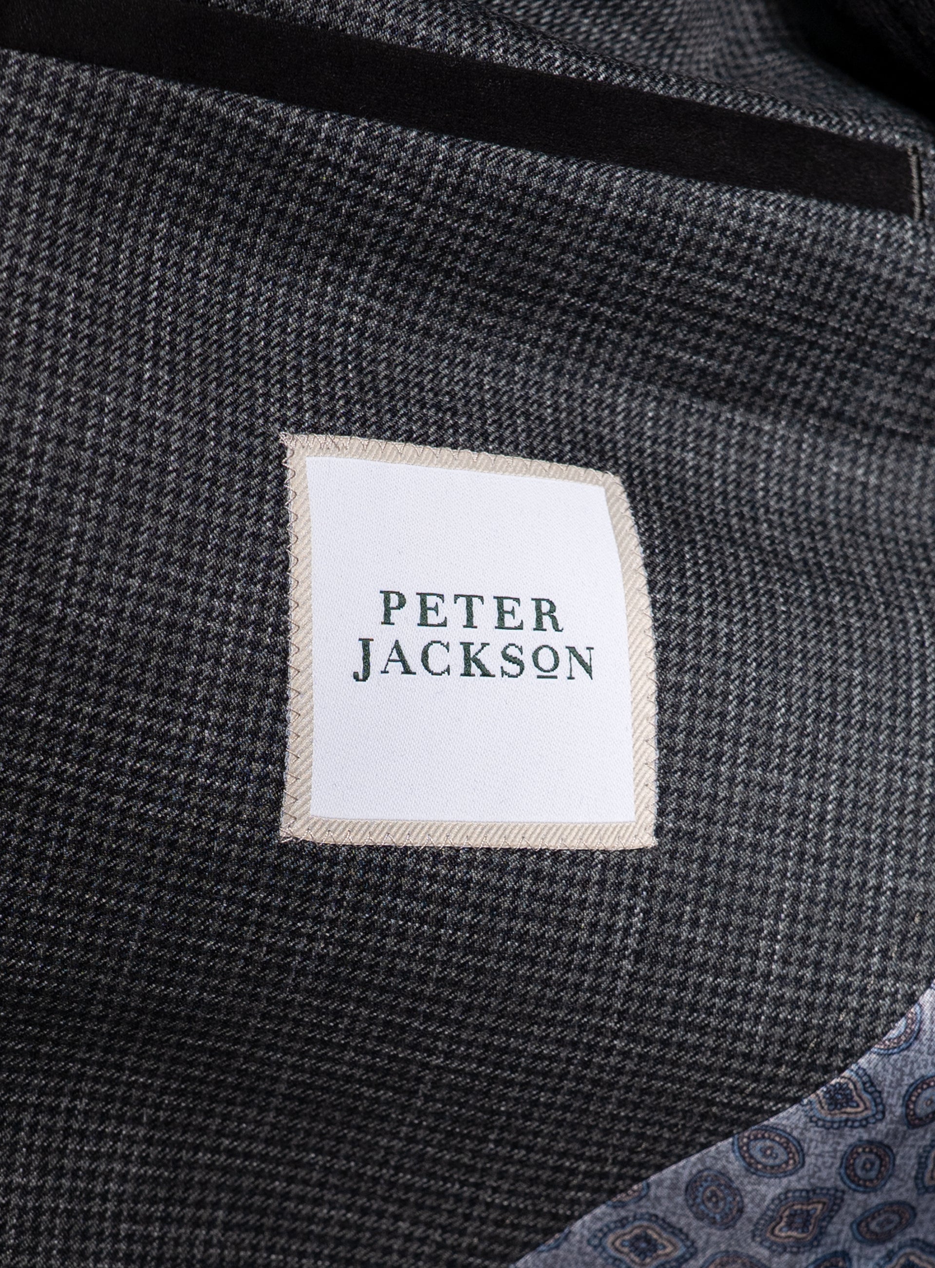 A label that has the "Peter Jackson" logo on the Portici Puppytooth Green Jacket