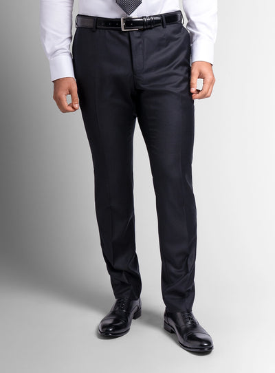 Person wearing black dress pants with a white shirt on a gray background
