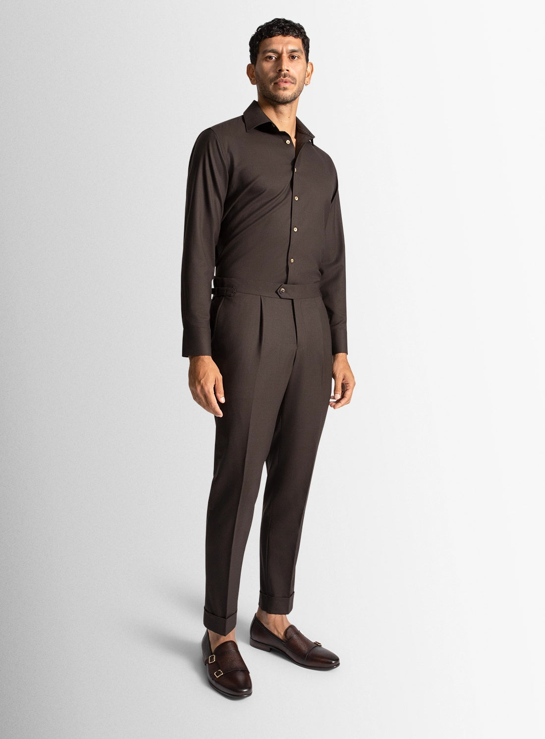 Man wearing a brown suit on a white background