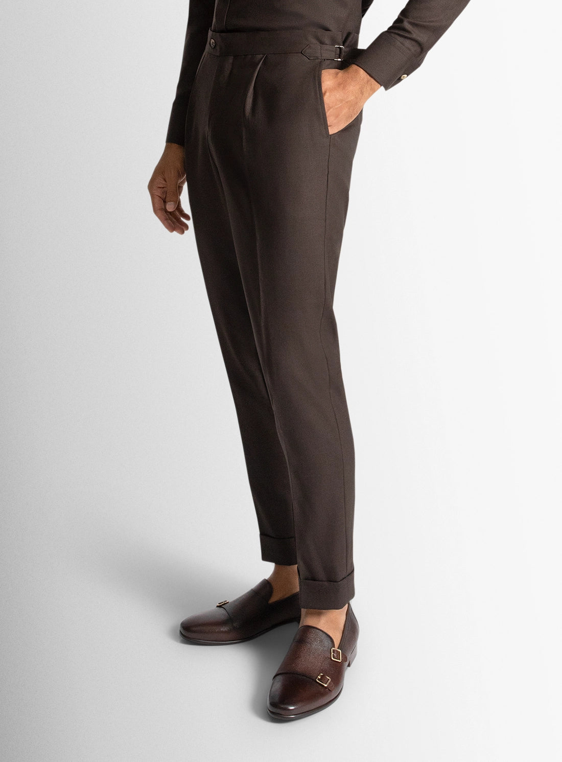 Brown pants worn by a person on a light gray background
