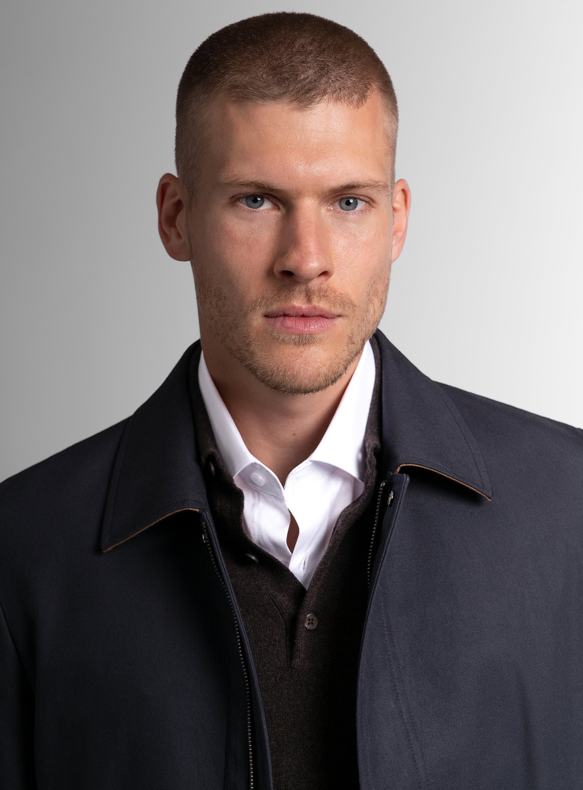 Close-up of a man wearing the Lorenzo Navy Raincoat