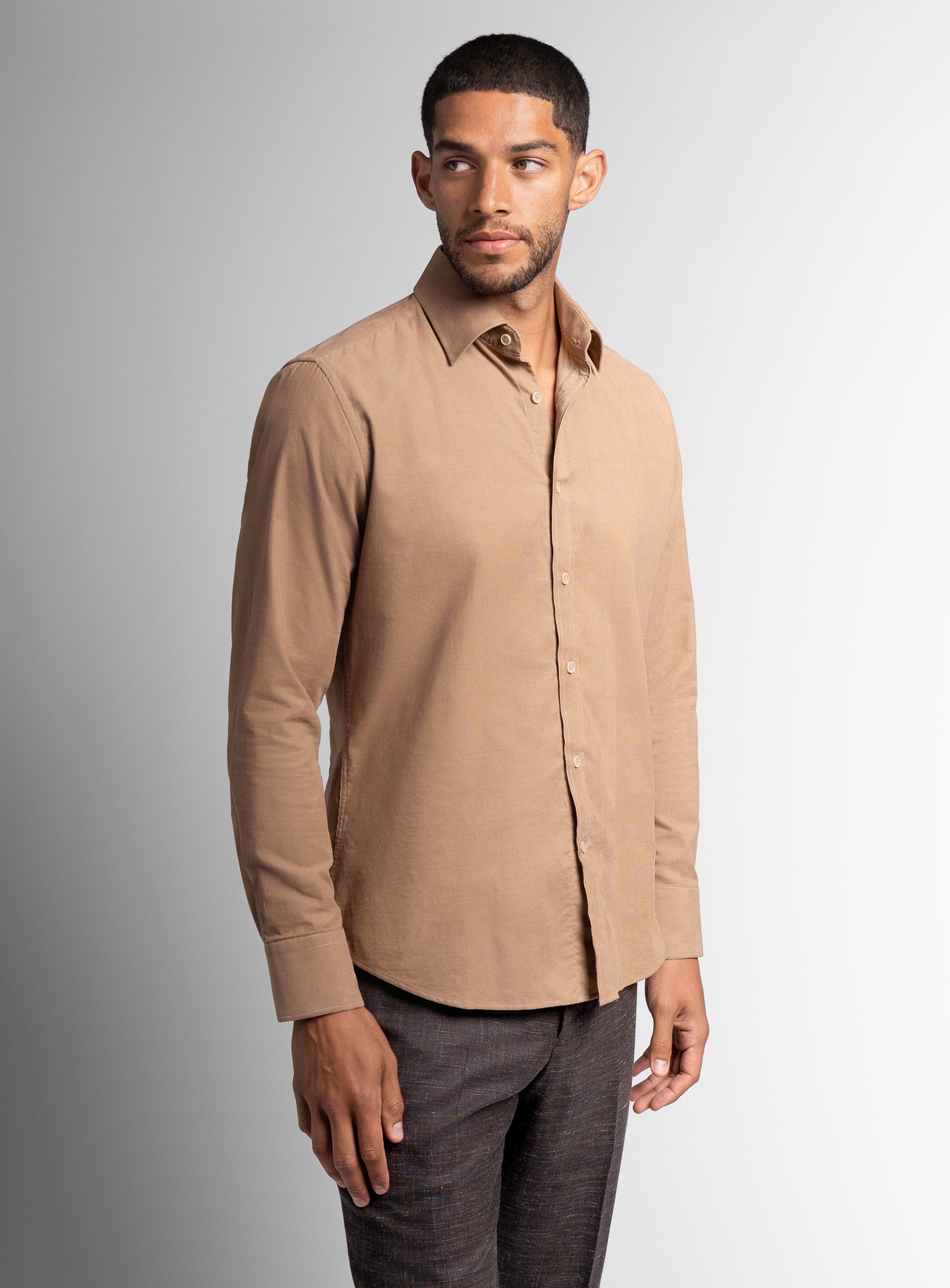 A man wearing the Piero Baby Cord Slim Fit Camel Shirt
