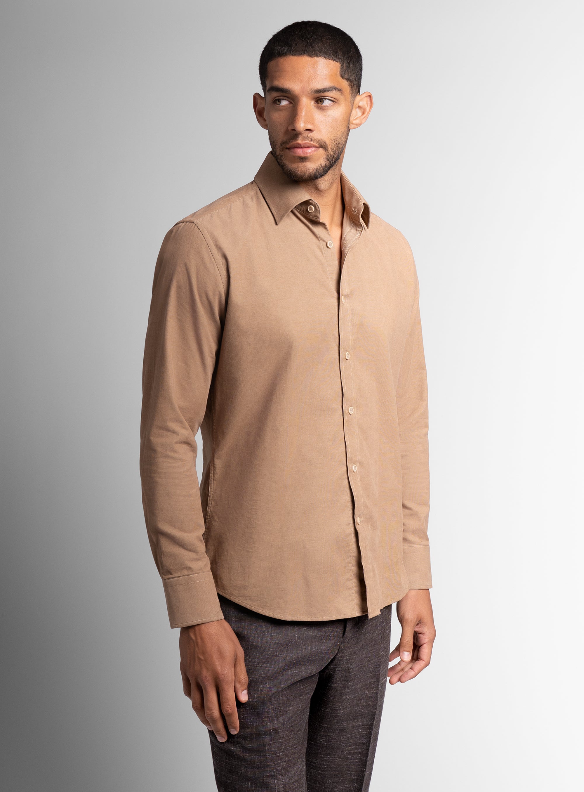 A man wearing the Piero Baby Cord Slim Fit Camel Shirt