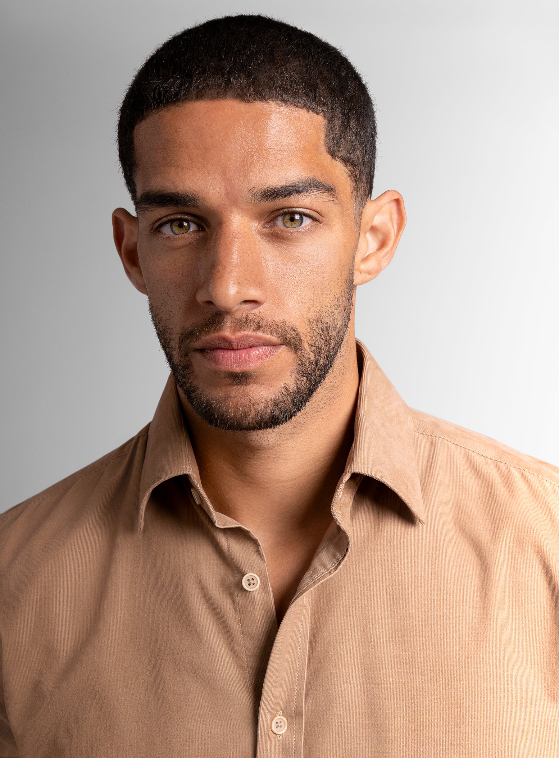 Close-up of a man wearing the Piero Baby Cord Slim Fit Camel Shirt