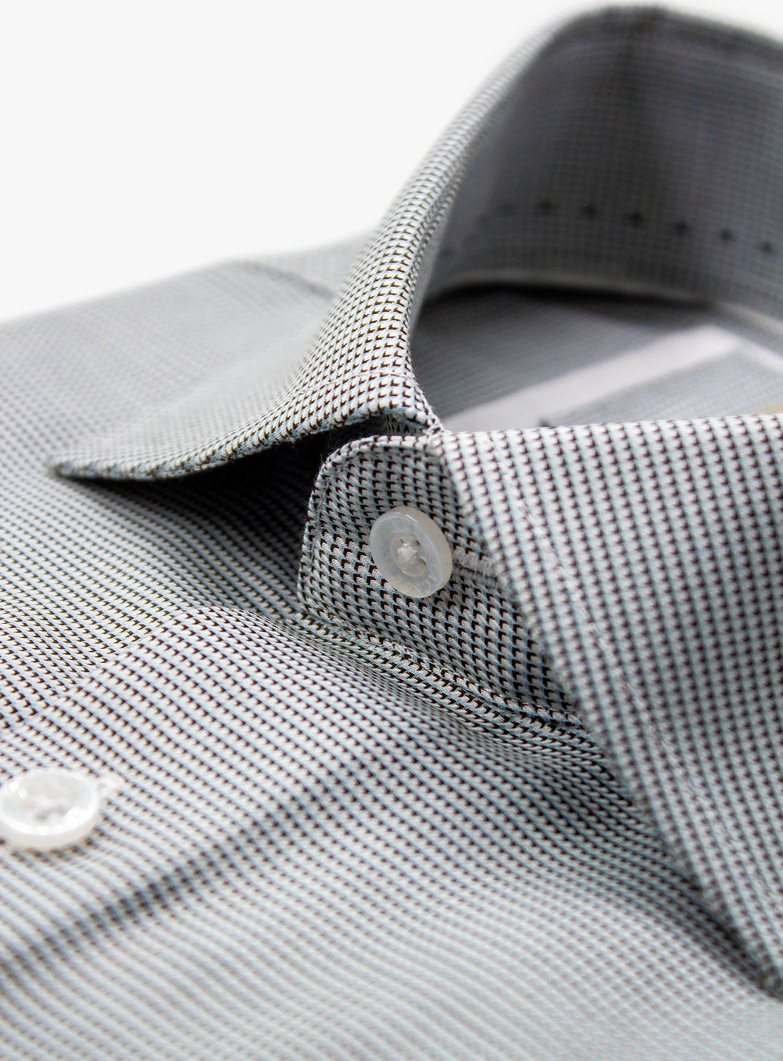 Close-up of a gray checkered shirt with a collar and buttons.