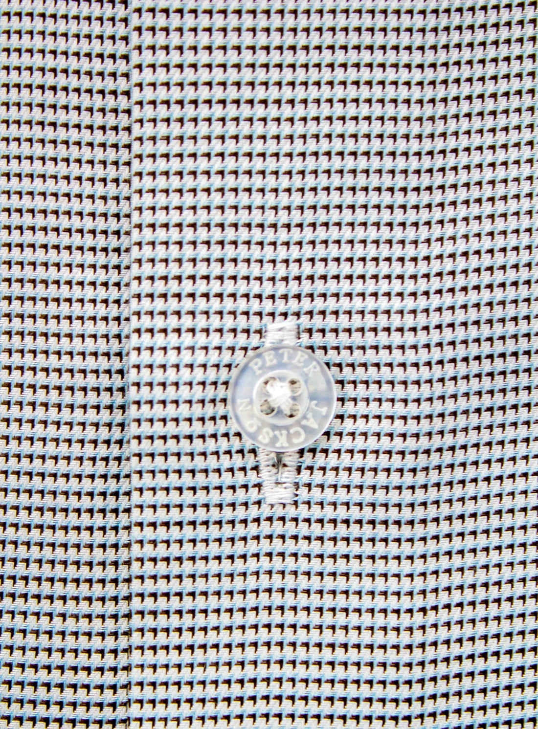 Close-up of a button on a textured fabric background
