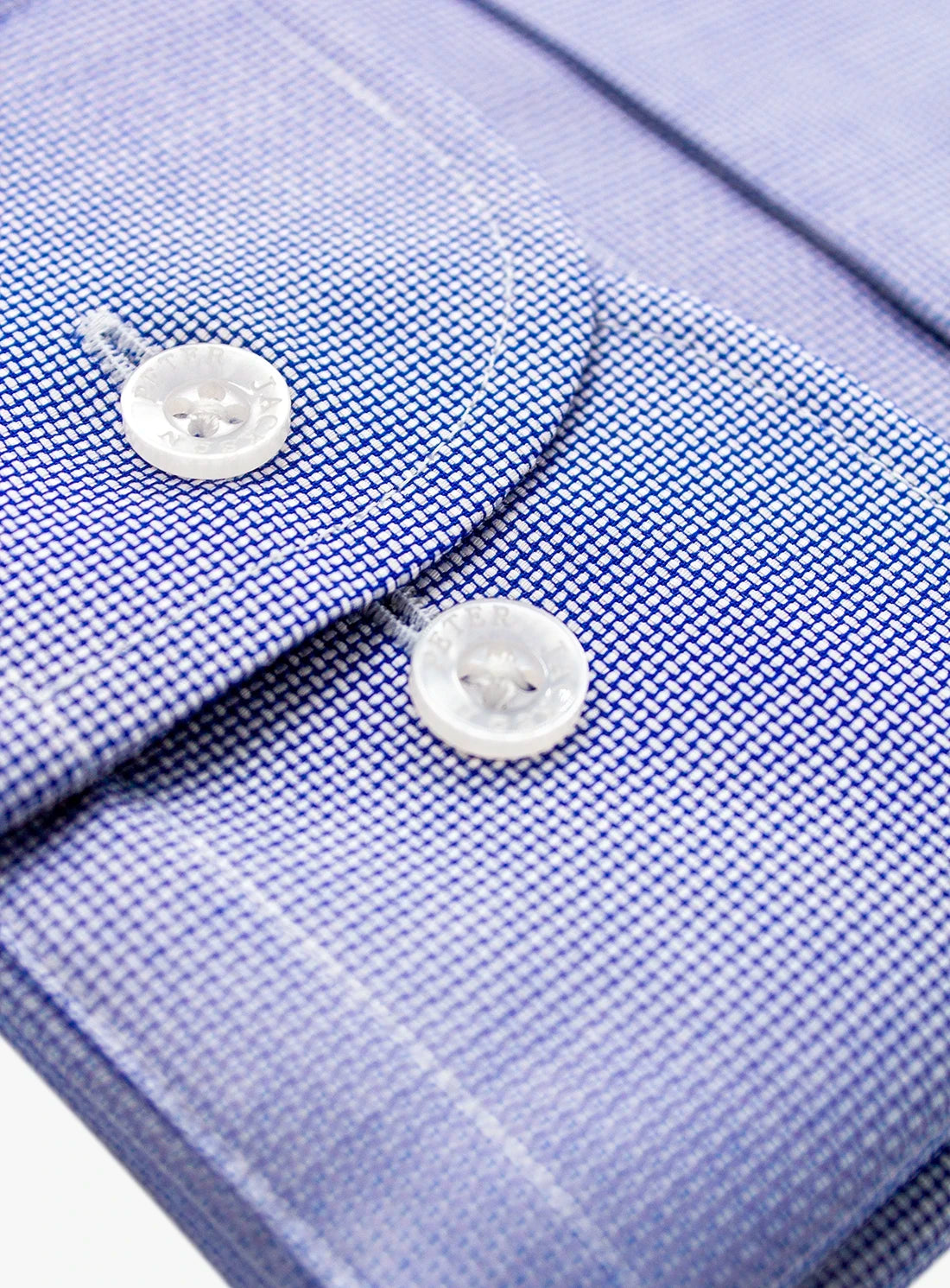 Close-up of a blue checkered shirt with buttons on a white background