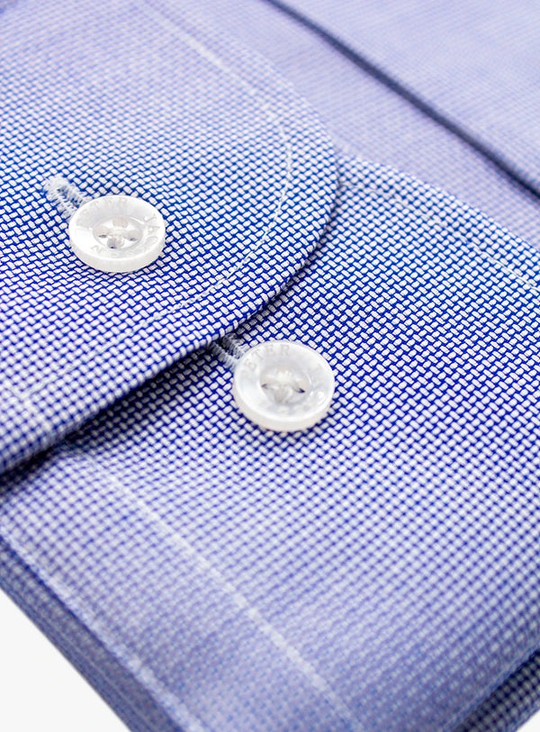 Close-up of a blue checkered shirt with buttons on a white background