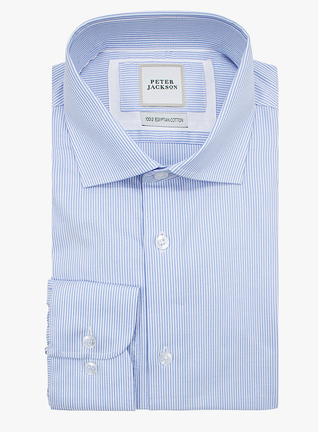 Folded blue and white striped dress shirt with 'Peter Jackson' label on a white background