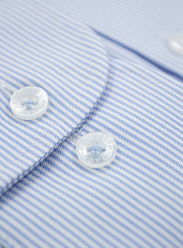 Close-up of a blue and white striped shirt with buttons.
