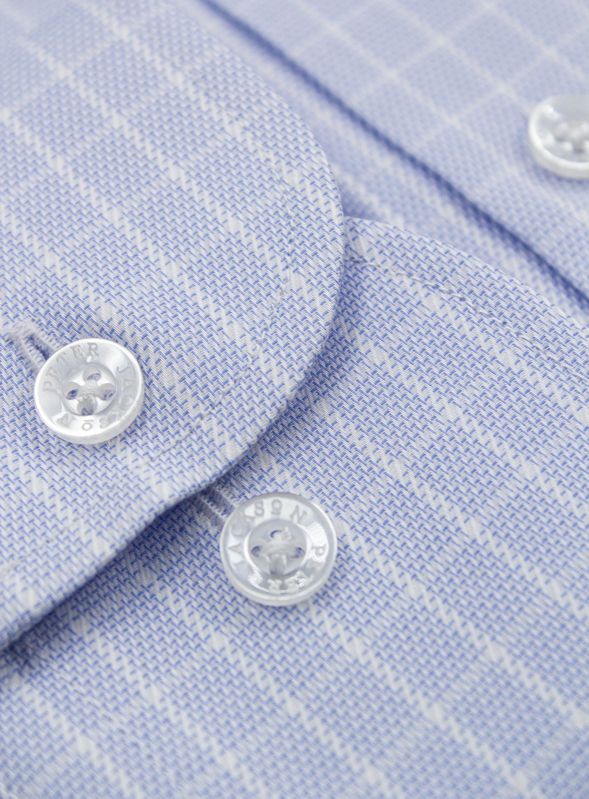 Close-up of a button on the Milan Micro Check Sky Blue Shirt