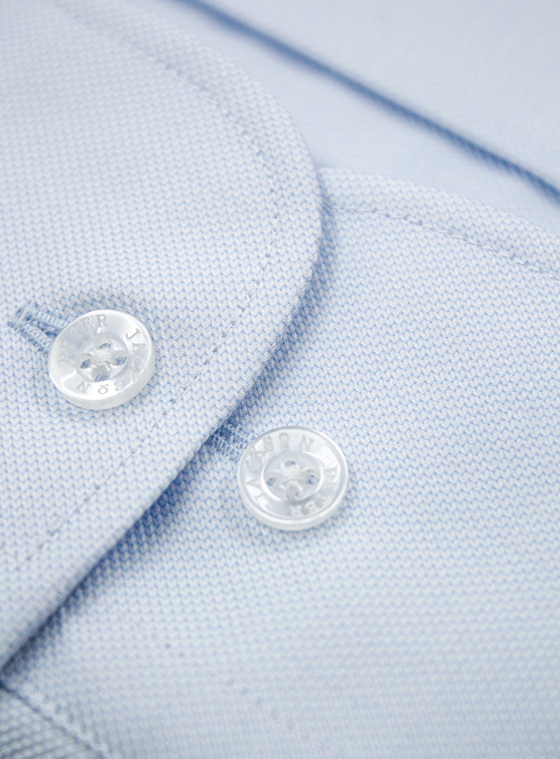 Close-up of a button on the Milan Luxe Weave Sky Blue Shirt