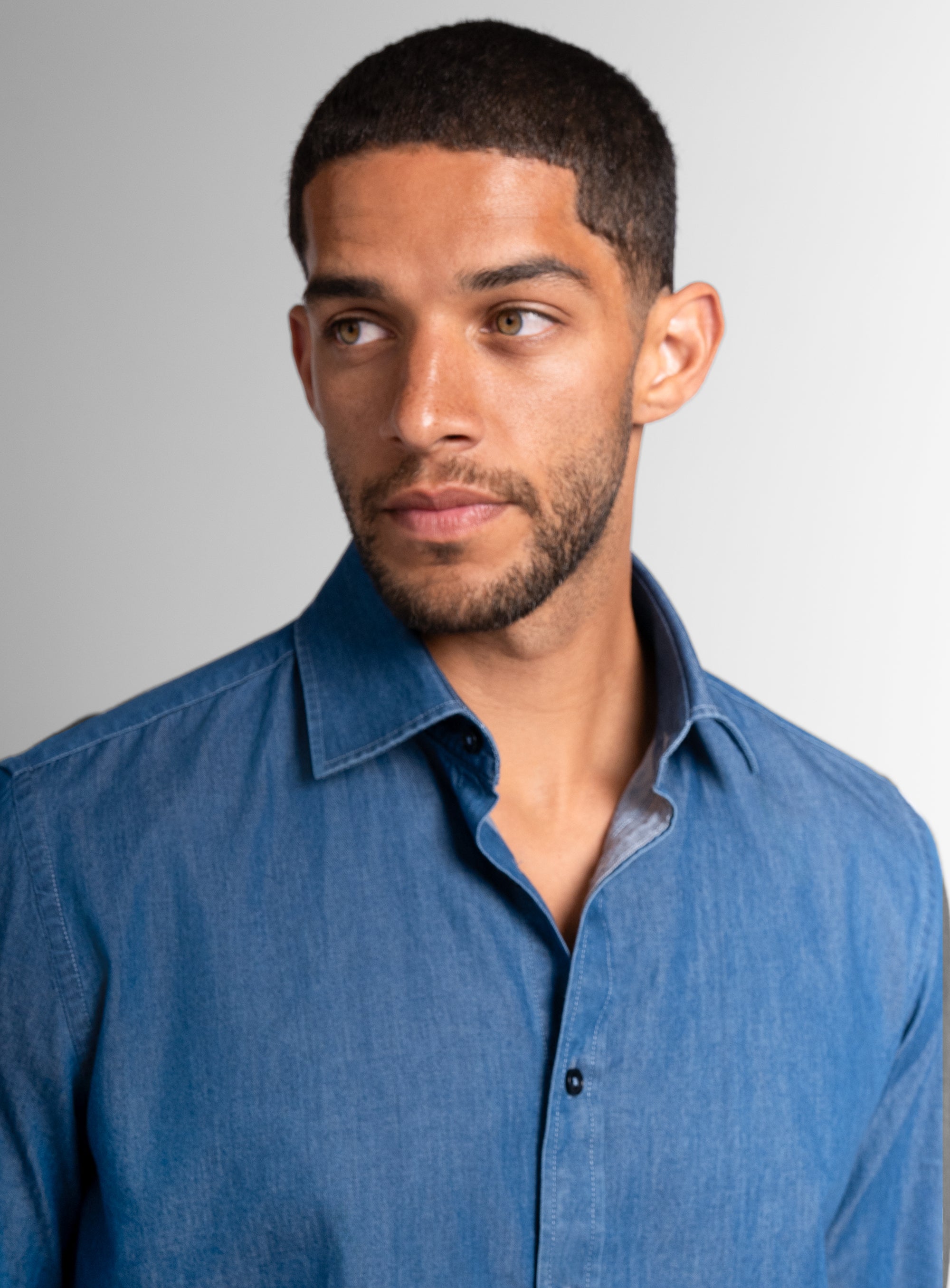 Close-up of a man wearing the Piero Washed Denim Blue Slim Fit Shirt