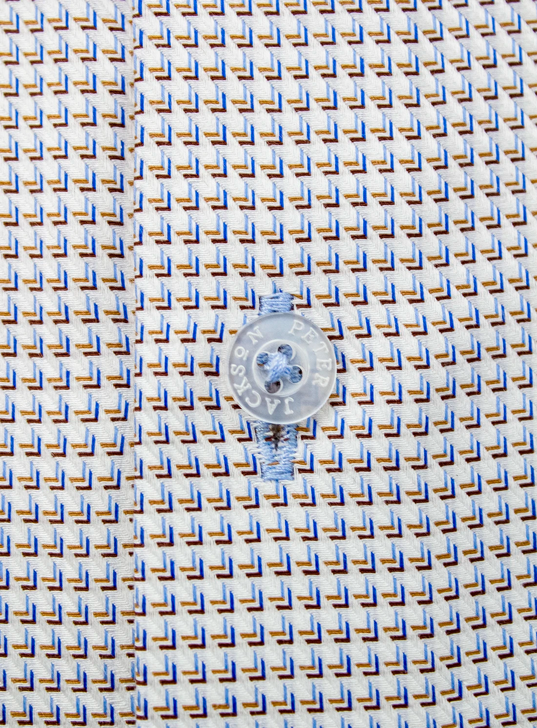 Small round object on a textured blue and beige background