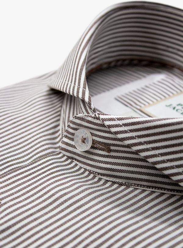 Close-up of a striped shirt with a button and collar detail on a white background