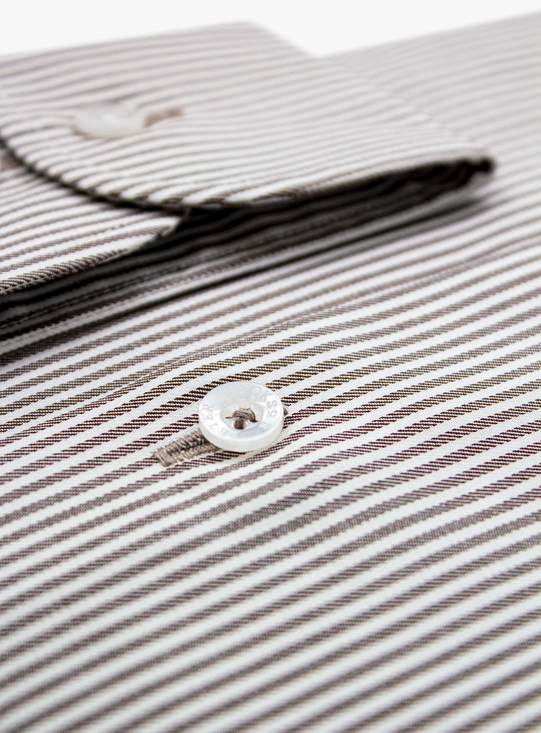 Close-up of a striped shirt with a button, focusing on texture and pattern.