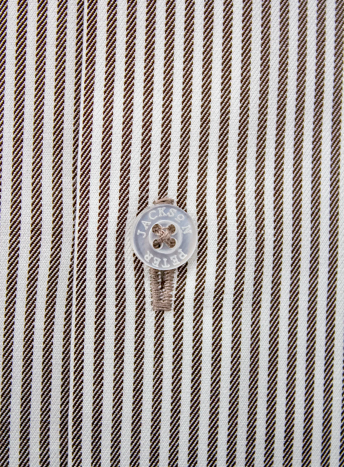 Close-up of a striped fabric with a button featuring the brand 'Jack & Jones'.