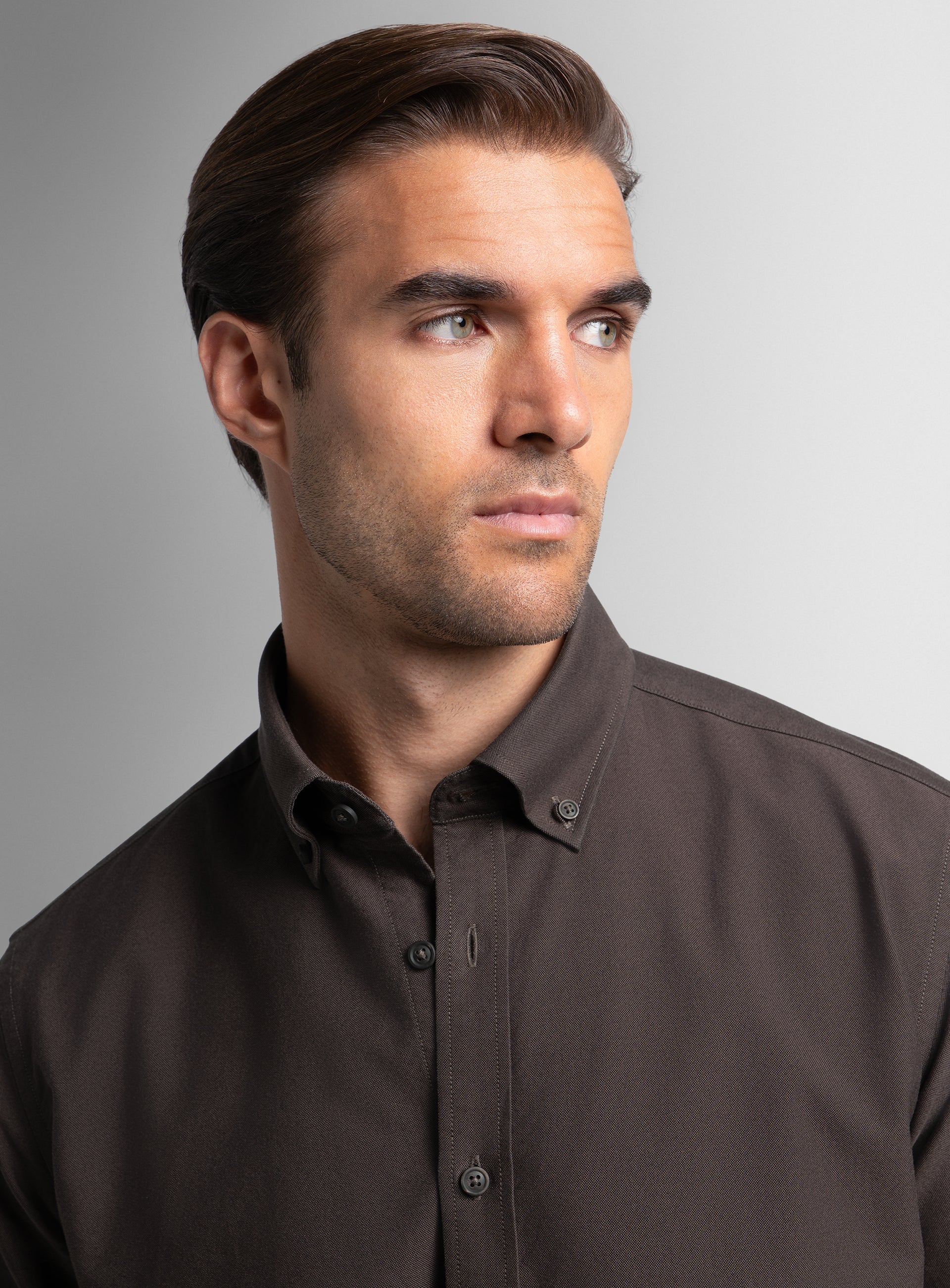 A close-up of a man wearing the Paolo Oxford Slim Fit Brown Shirt