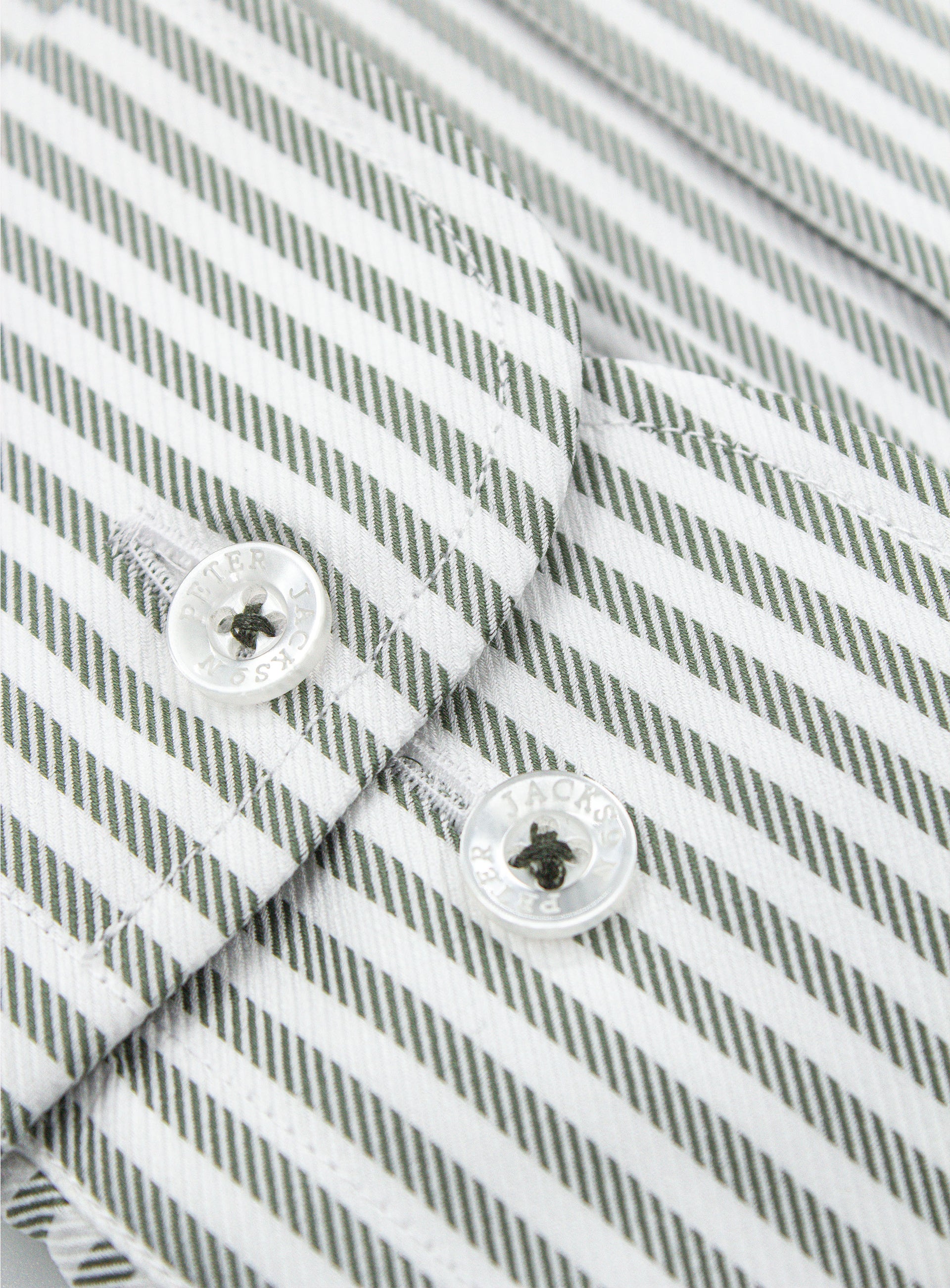 Close-up of a button on the Milan Striped Green Shirt
