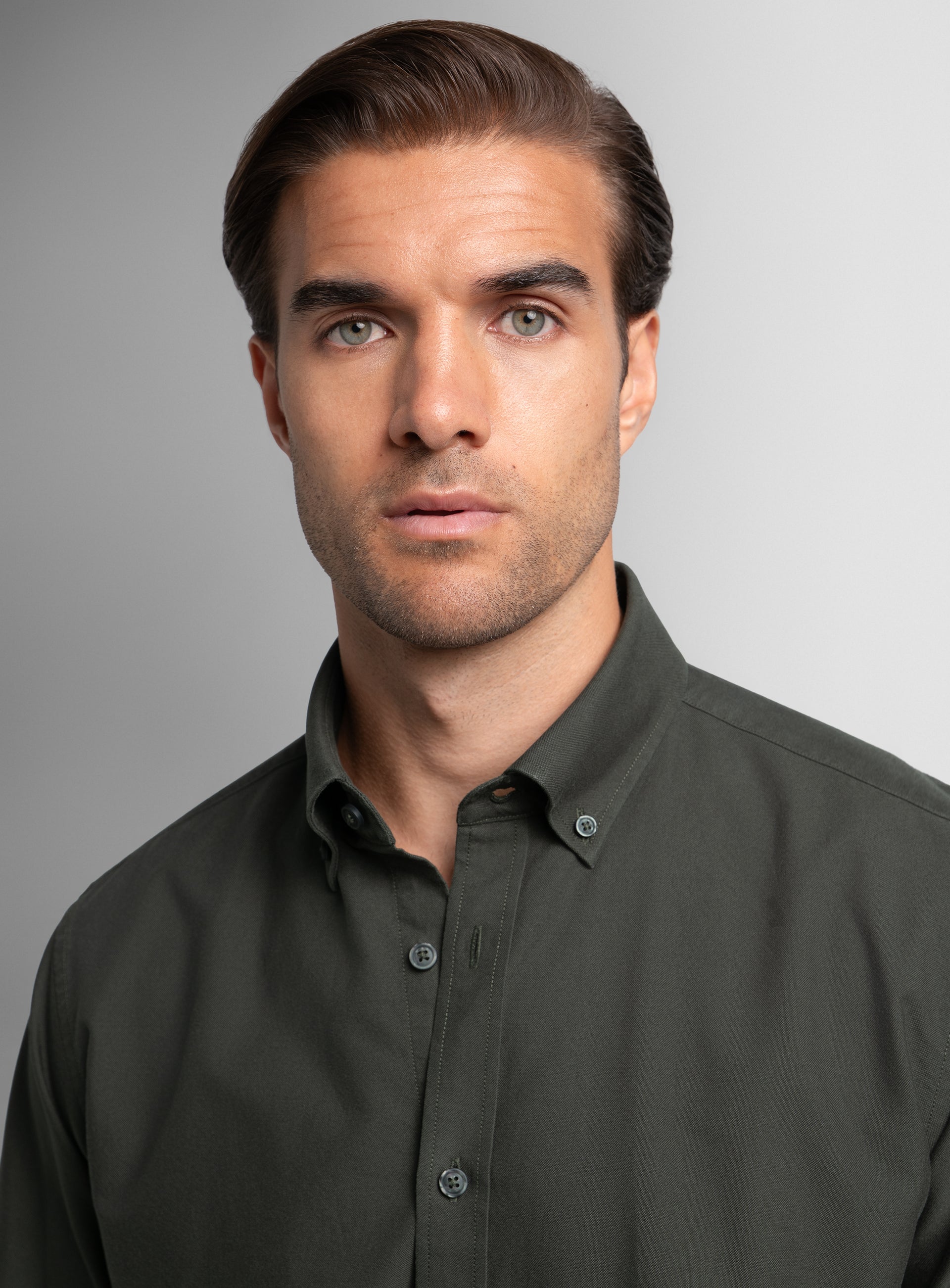 Close-up of a man wearing the Paolo Oxford Slim Fit Olive Green Shirt