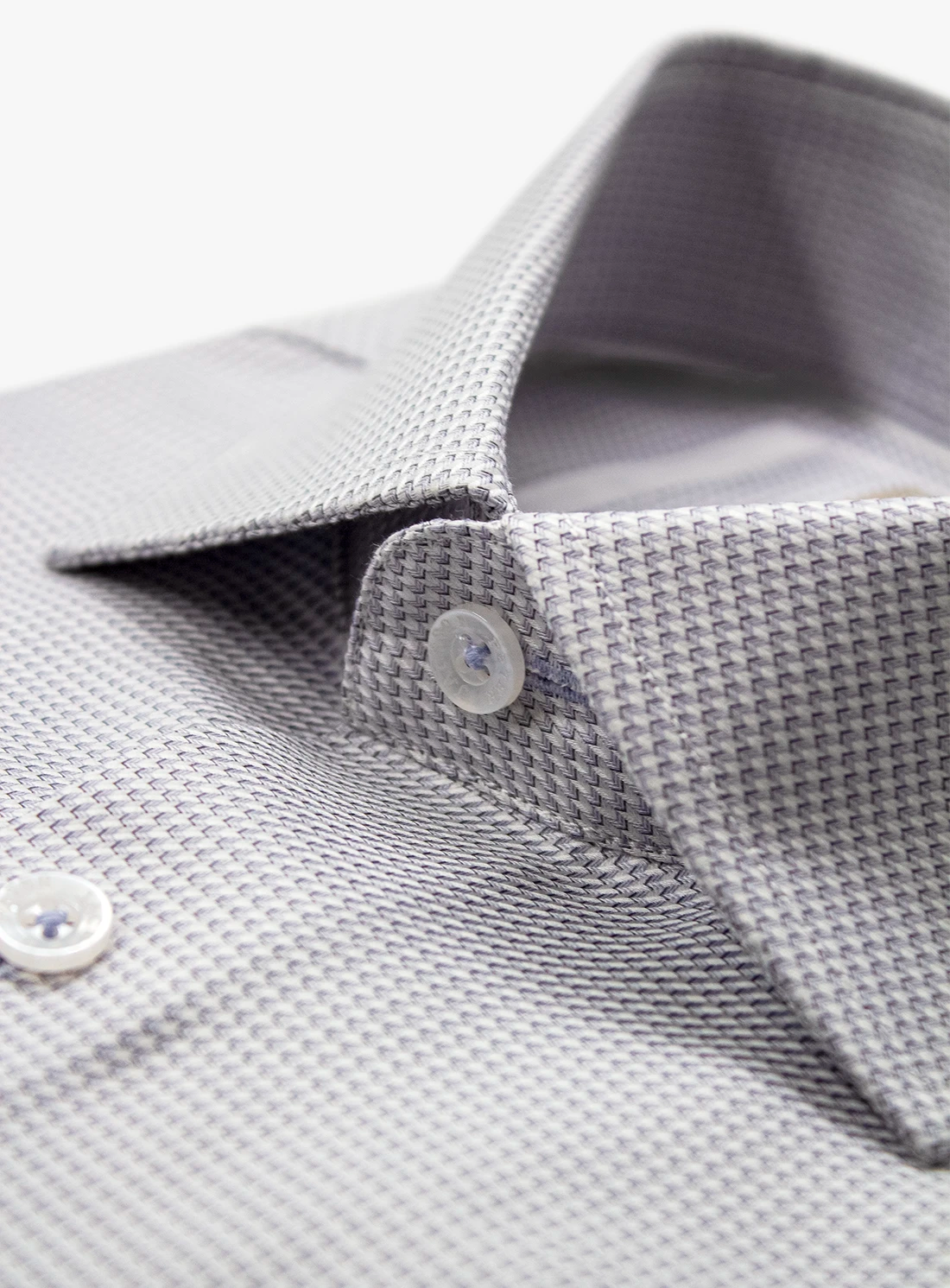 Close-up of a gray textured shirt with collar and buttons on a white background