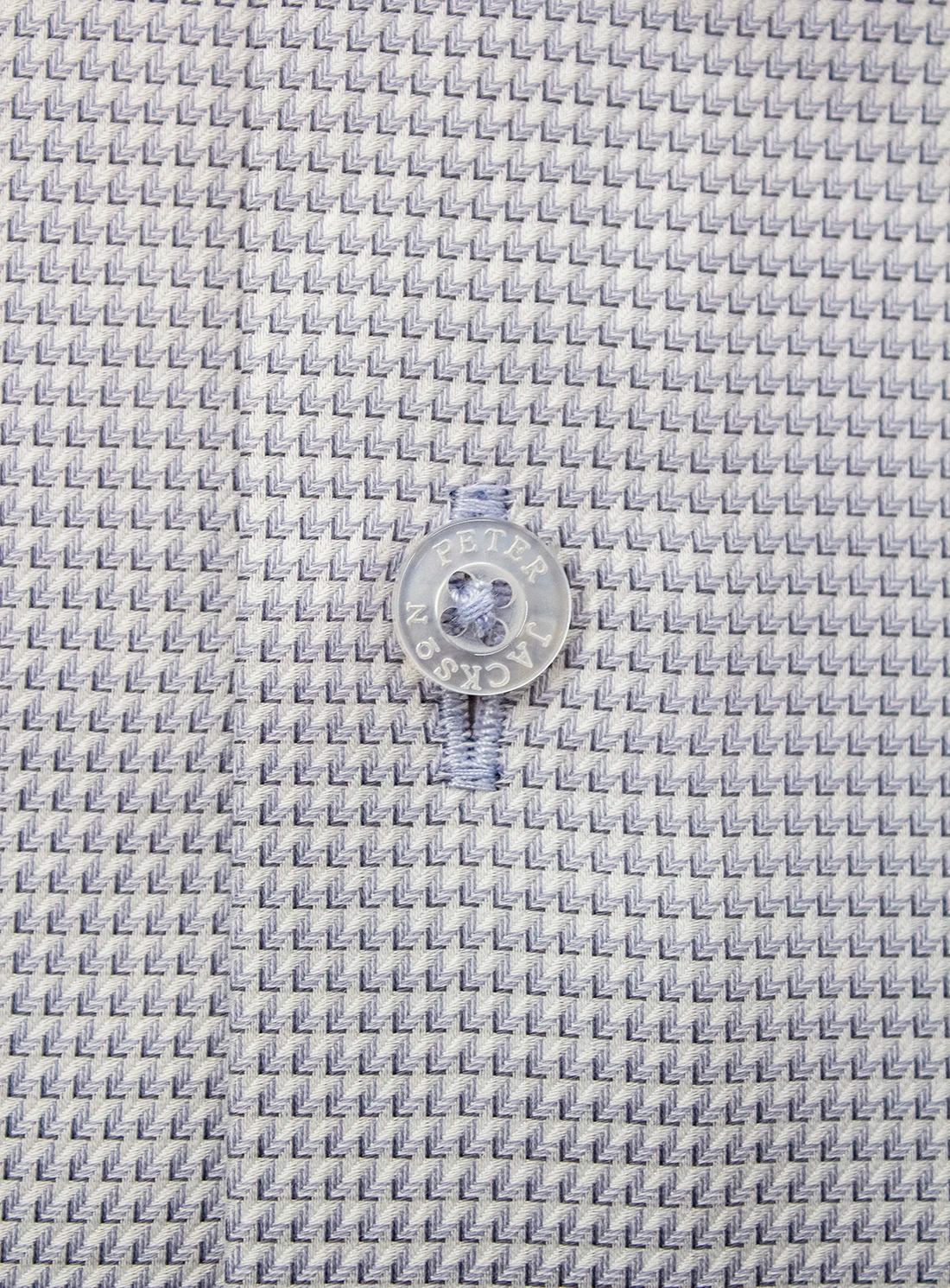 Close-up of a textured fabric with a button in the center.