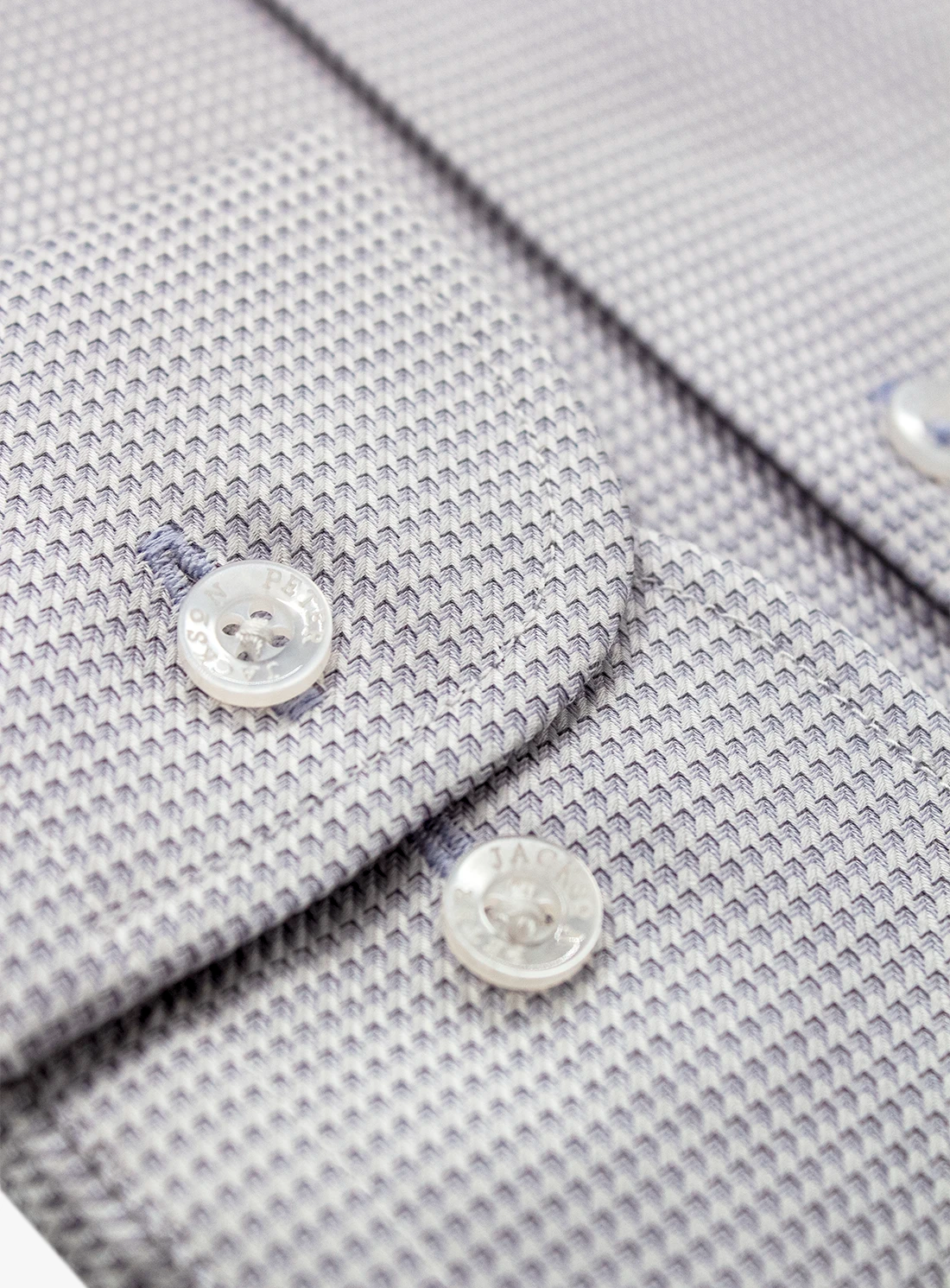 Close-up of a gray textured shirt with buttons