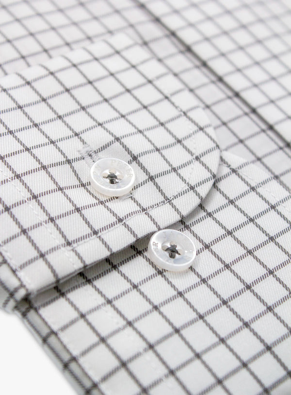 Close-up of a checkered shirt with buttons on a white background