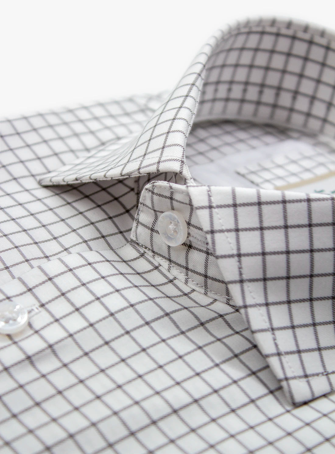 Close-up of a checkered shirt with a button detail