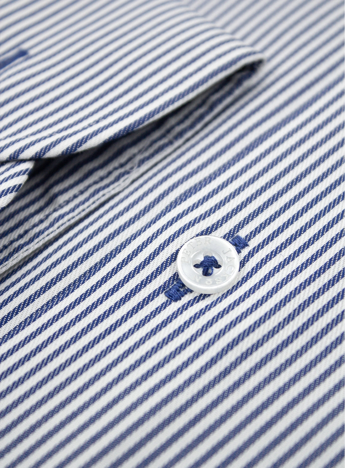 Close-up of a blue and white striped shirt with a button.