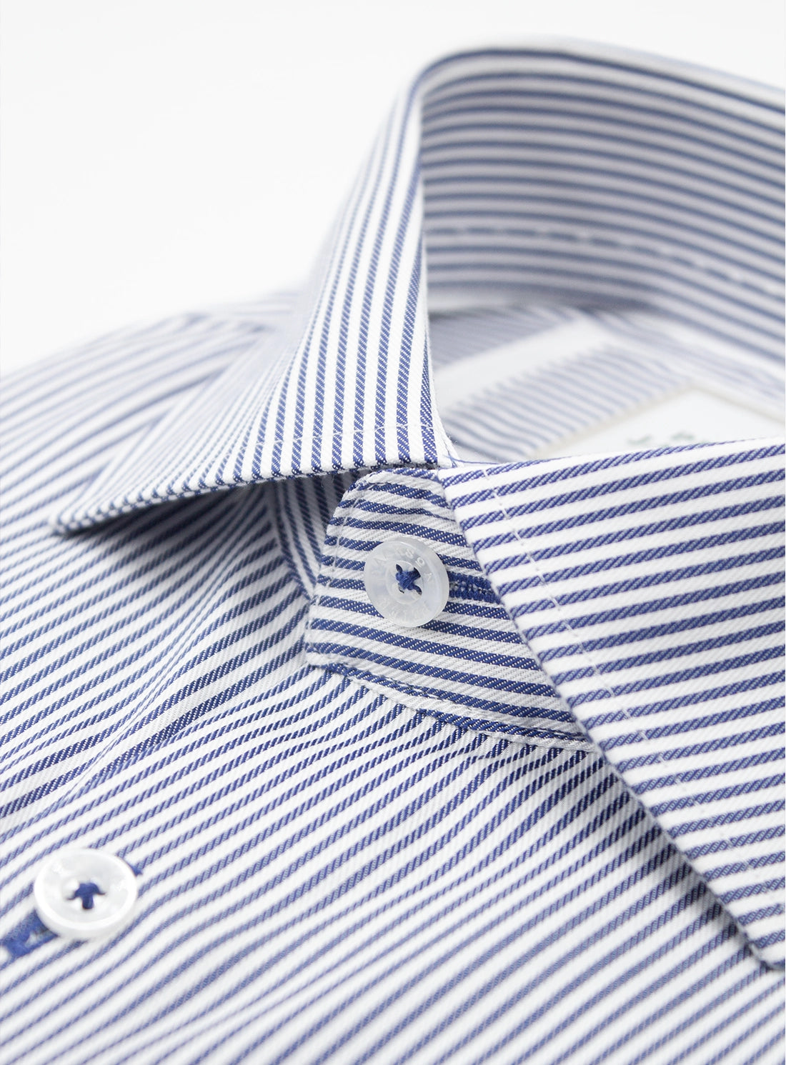 Close-up of a blue and white striped shirt with a button