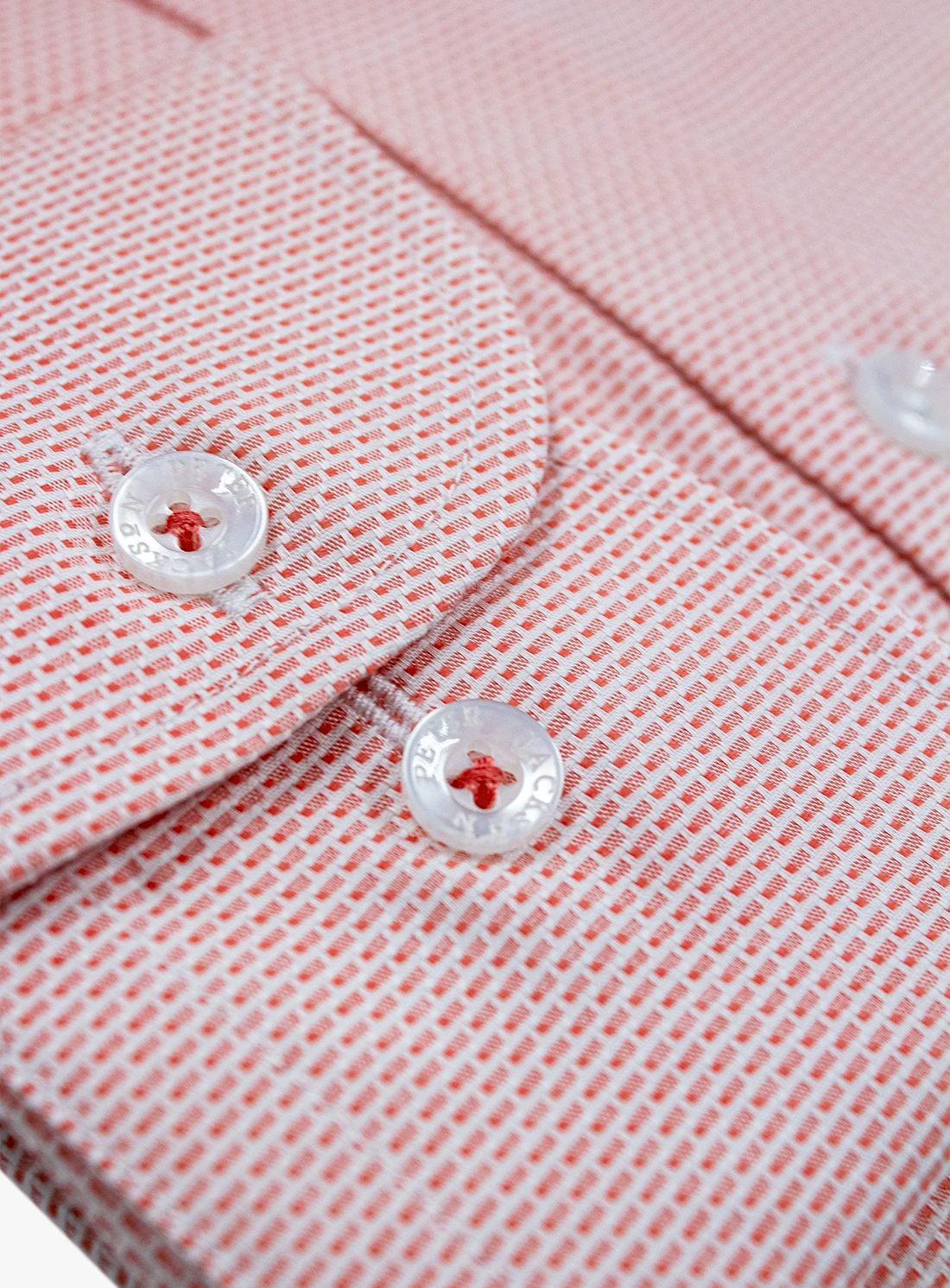 Close-up of a pink textured shirt with buttons